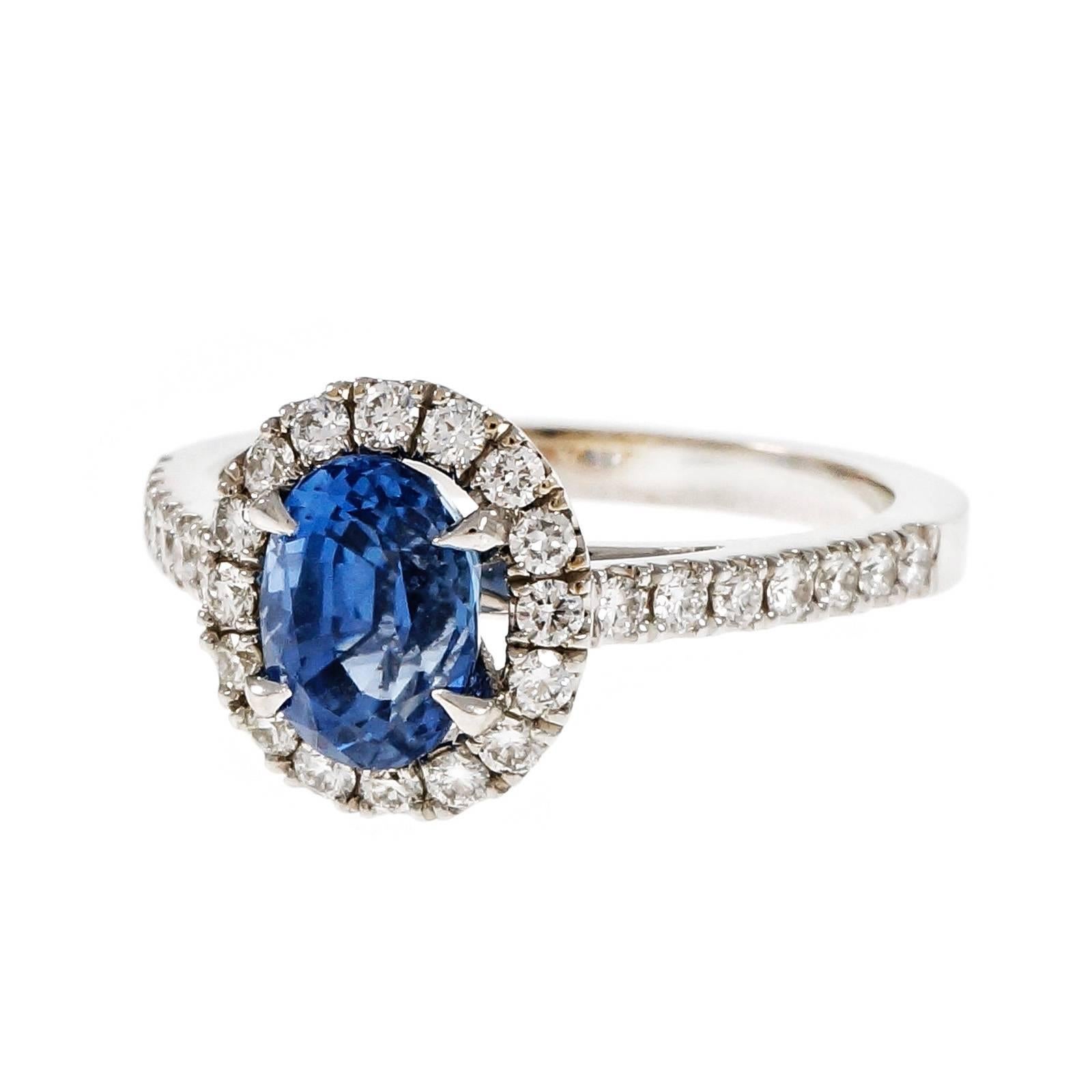Peter Suchy 18k white gold Halo engagement ring with a bright medium blue center oval Sapphire AGL certified simple heat only. The ring is designed to fit a wedding band flush against it.

1 oval blue sapphire, approx. total weight 1.77cts, simple