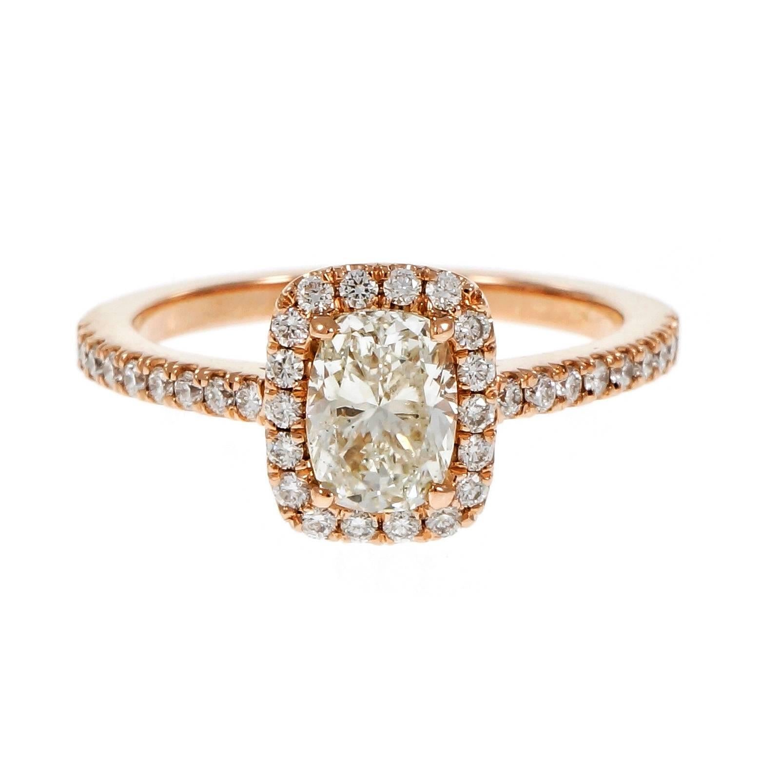From the Peter Suchy Workshop, original cushion cut GIA certified diamond in a 14 rose gold setting with a halo of round full cut diamonds. 

1 cushion diamond, approx. total weight .90cts, L, I1, GIA certificate #1172282057
36 round full cut