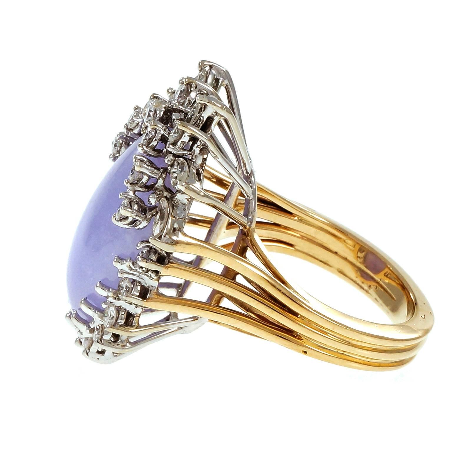 Large natural purple GIA certified oval Jadeite Jade and diamond cocktail ring circa 1950 with round and Marquise diamonds. Handmade ring with yellow gold shank and white gold top.

1 oval translucent purple Jadeite Jade, 19.51 x 15.07 x 6.13mm,