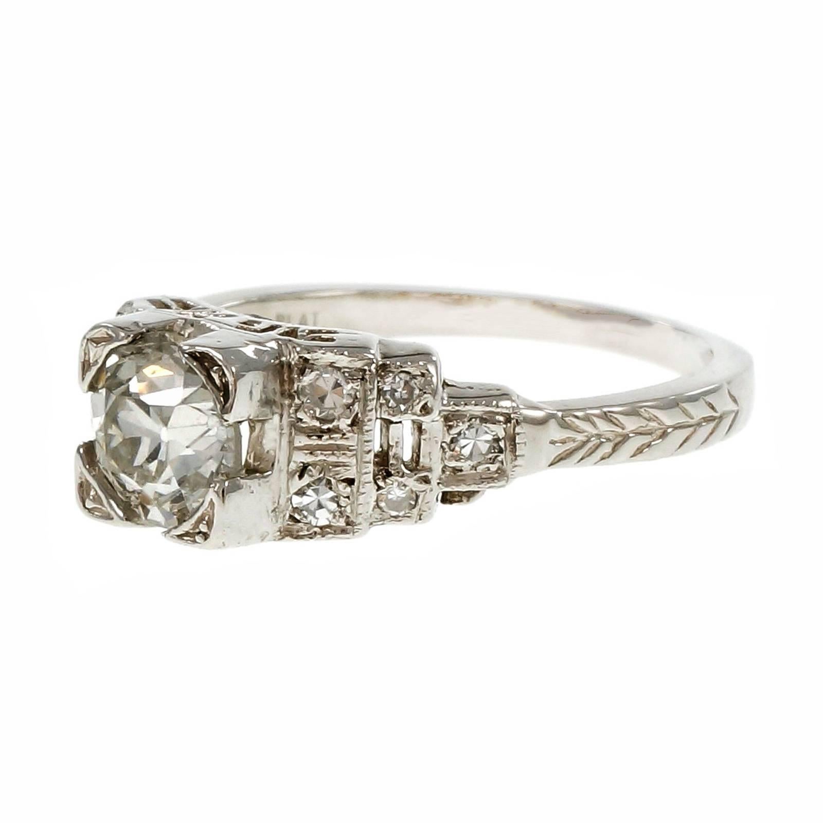 Art Deco 1930-1939 Diamond Platinum engagement ring with step design shoulders engraving and filigree work. Original old European cut bright sparkly diamonds. 

1 old European cut diamond, approx. total weight .88cts, G – H, SI3, 
10 round diamonds,