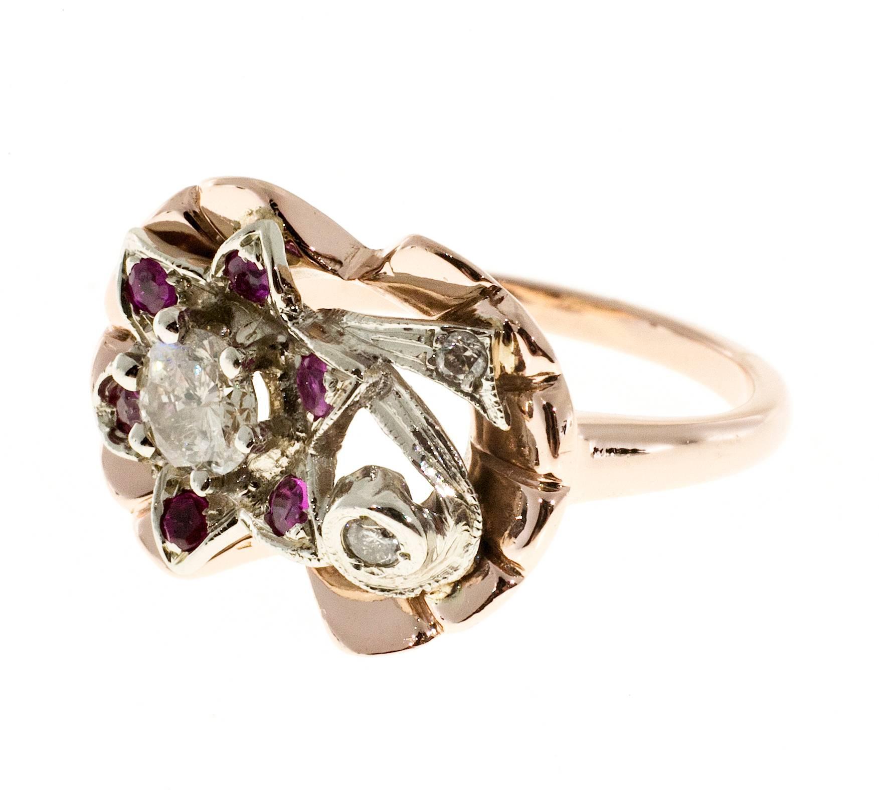 1930's rose and white gold diamond and Ruby cocktail flower design ring. design top.

1 round diamond, approx. total weight .20cts, G, SI1
2 round diamonds, approx. total weight .04cts, H, SI
6 round red Rubies, approx. total weight .24cts
Size: