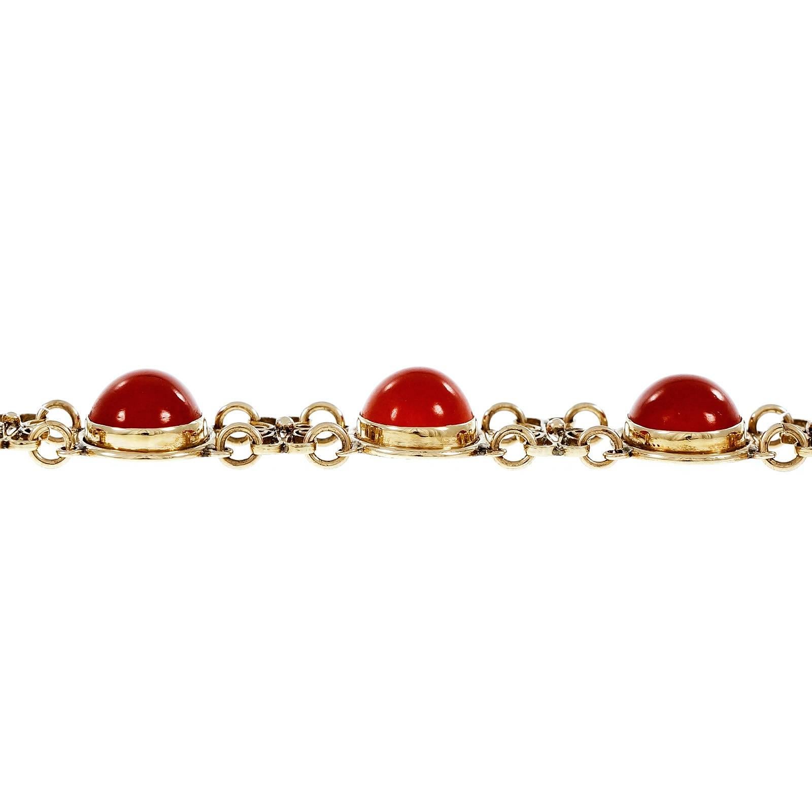 Oval Orange Red Natural Coral Gold Bracelet. Circa 1940.

8 oval cabochon orange red Coral, 11.73 x 8.44 x 4.45mm, GIA certificate #2171882584
14k yellow gold
16.6 grams
Tested: 14k
Stamped:  585
Chain: 7.5 inches – Width: 14.49mm – Depth: