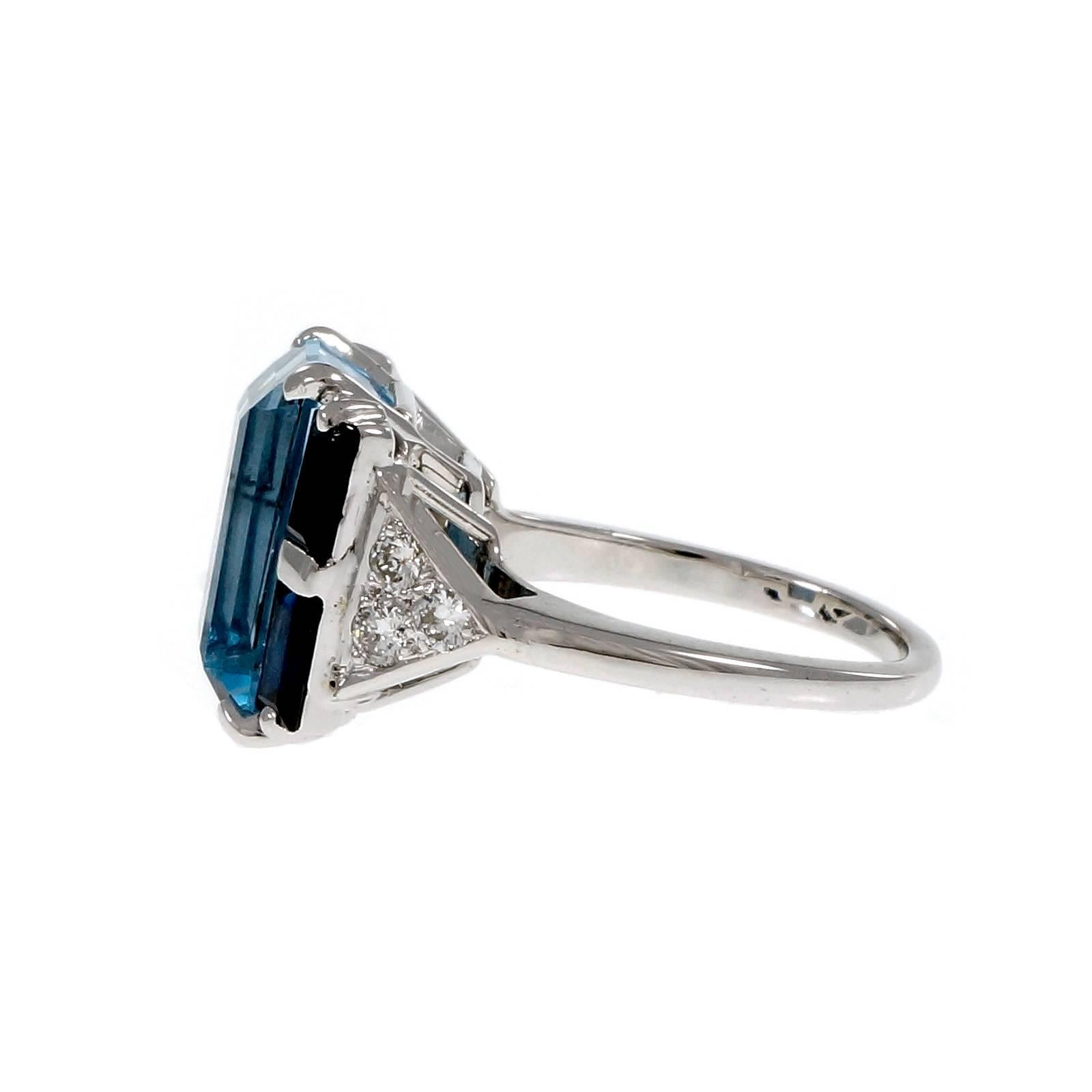 1930’s Art Deco fine gem Aqua Sapphire diamond cocktail ring. Late Deco design.

1 Emerald cut blue Aquamarine, approx. total weight 6.80cts, VS1
4 Emerald cut fine blue Sapphires, approx. total weight 1.41cts, VS
6 round diamonds, approx. total