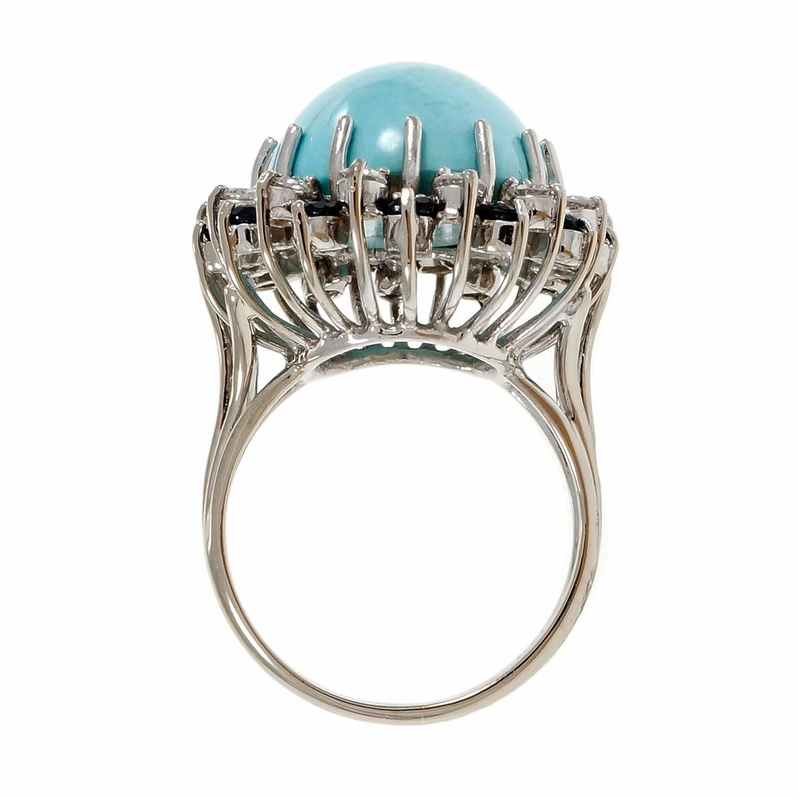 1950-1959 mid-century natural color bright blue Turquoise ring surrounded by bright Sapphires and diamonds. Certified natural color impregnated for stability with a proprietary polymer.

1 oval Robin’s Egg blue cabochon Turquoise, approx. total