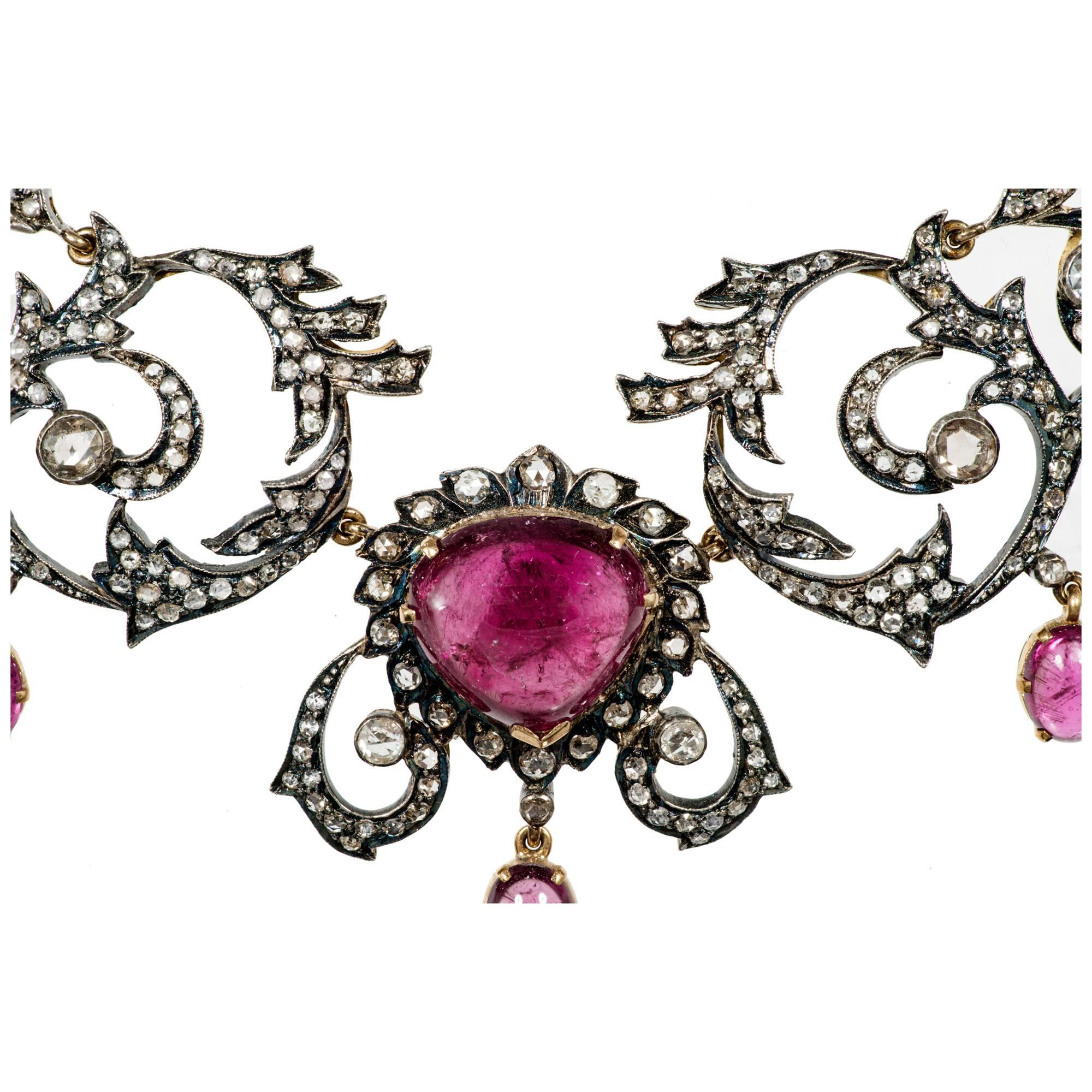 Circa 1890's pink oval tourmaline and round diamond pendant necklace. Handmade 14k gold with silver tops. Set with rose cut diamonds. Natural patina.

24 Pink tourmalines approx. weight. 25.00cts
425 Mixed diamonds  approx. weight. 6.50cts
14k