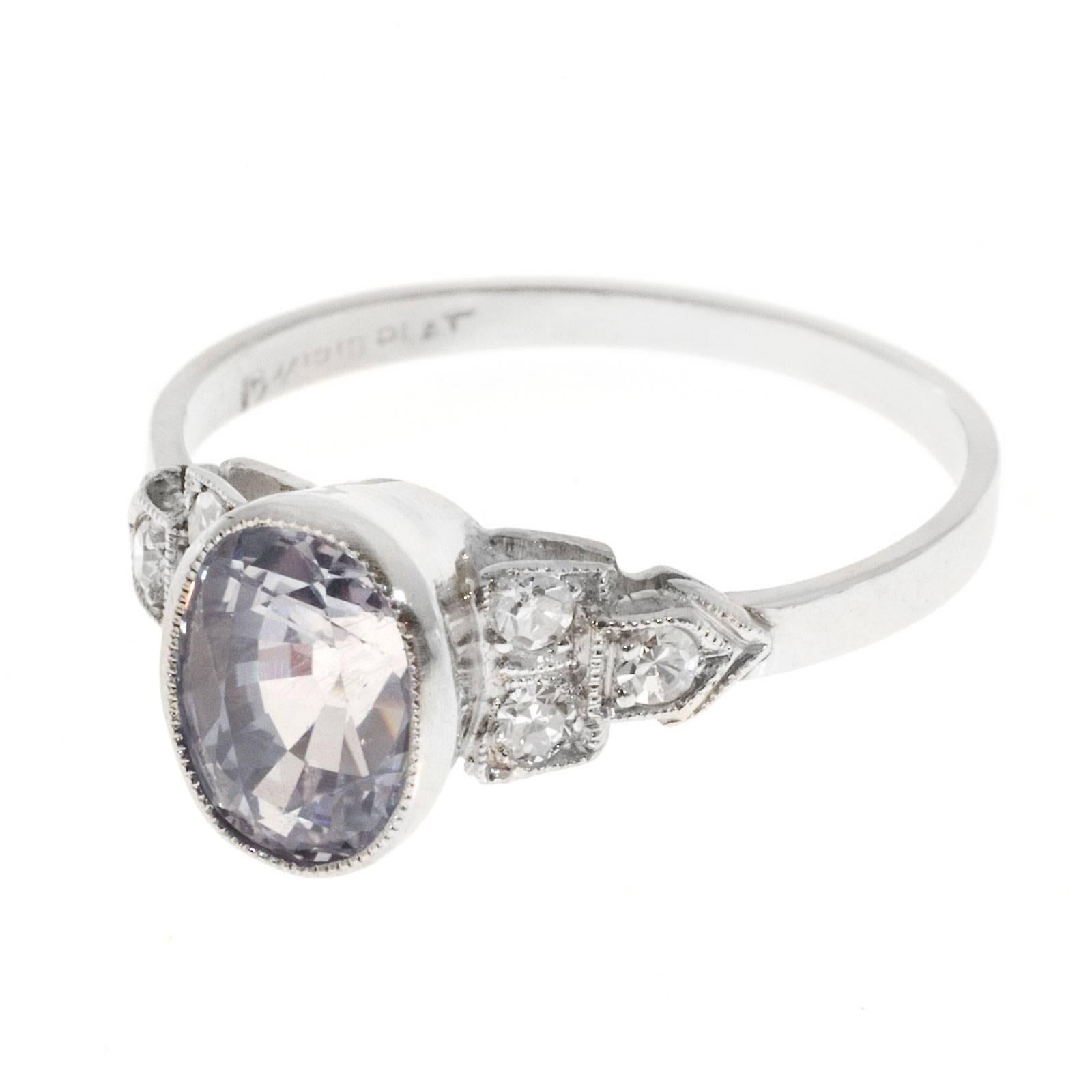 Oval very light pink blue Sapphire Art Deco engagement ring circa 1930 to 1940. In a platinum setting with 6 side diamonds.

1 oval near colorless very light pinkish blue Sapphire, approx. total weight 2.06cts, VS2, 7.87 x 5.74 x 5.12mm, Simple heat