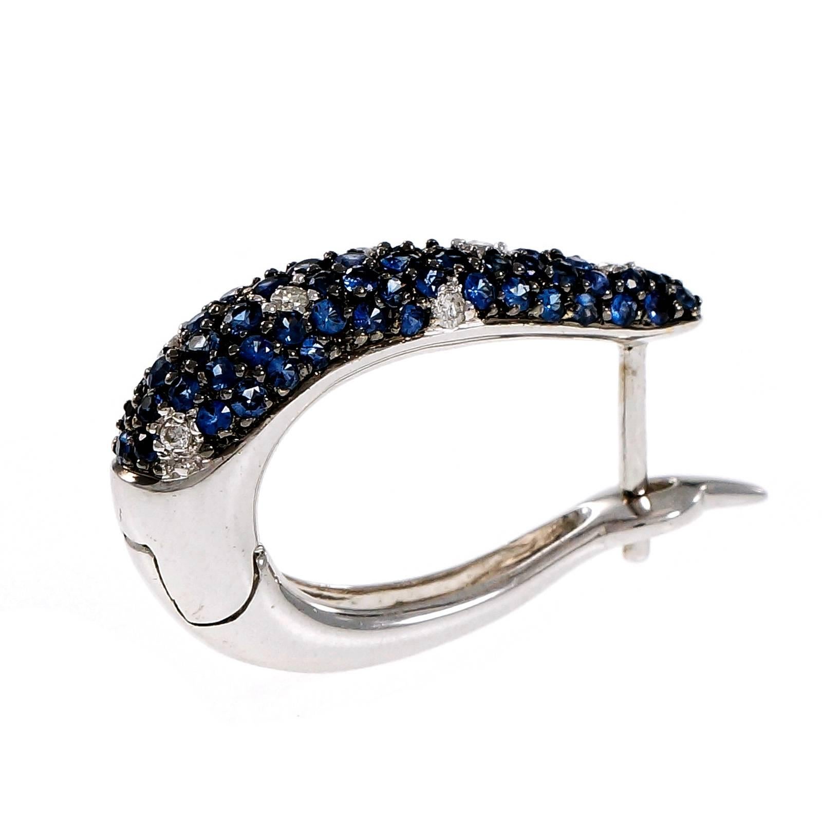 Beautiful hoop earrings set with bright blue Sapphires accented by white diamonds. Hinged backs. All 18k white gold. Post tops.

112 round blue Sapphires, approx. total weight 2.75cts
14 round diamonds, approx. total weight .20cts, H, VS –