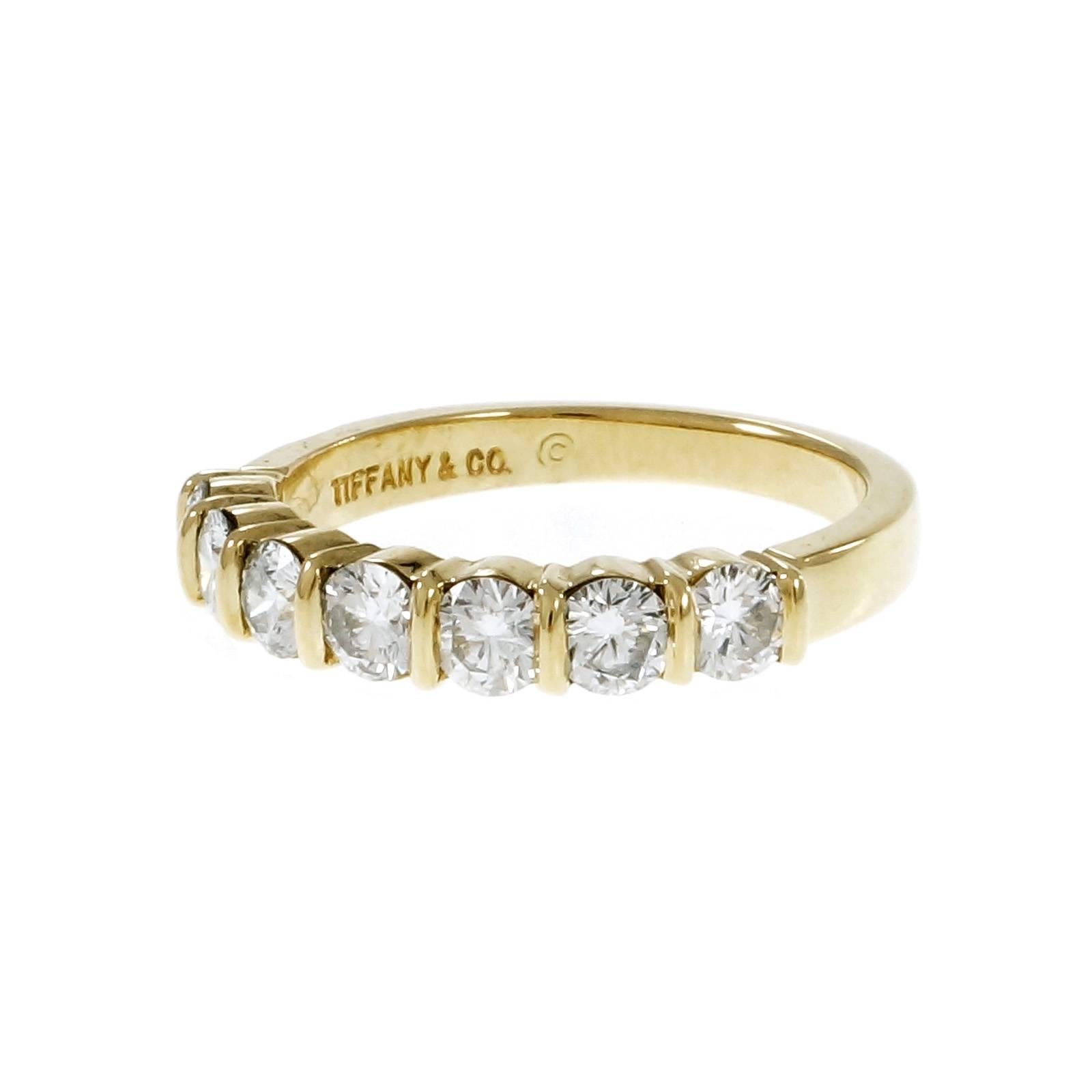 Tiffany & Co authentic 7 round diamond curved bar set wedding 18k yellow gold band.

7 round diamonds, approx. total weight .91cts, F, VS
18k yellow gold
Tested: 18k
Stamped: 750
Hallmark: Tiffany & Co
4.0 grams
Width at top: 3.52mm
Height