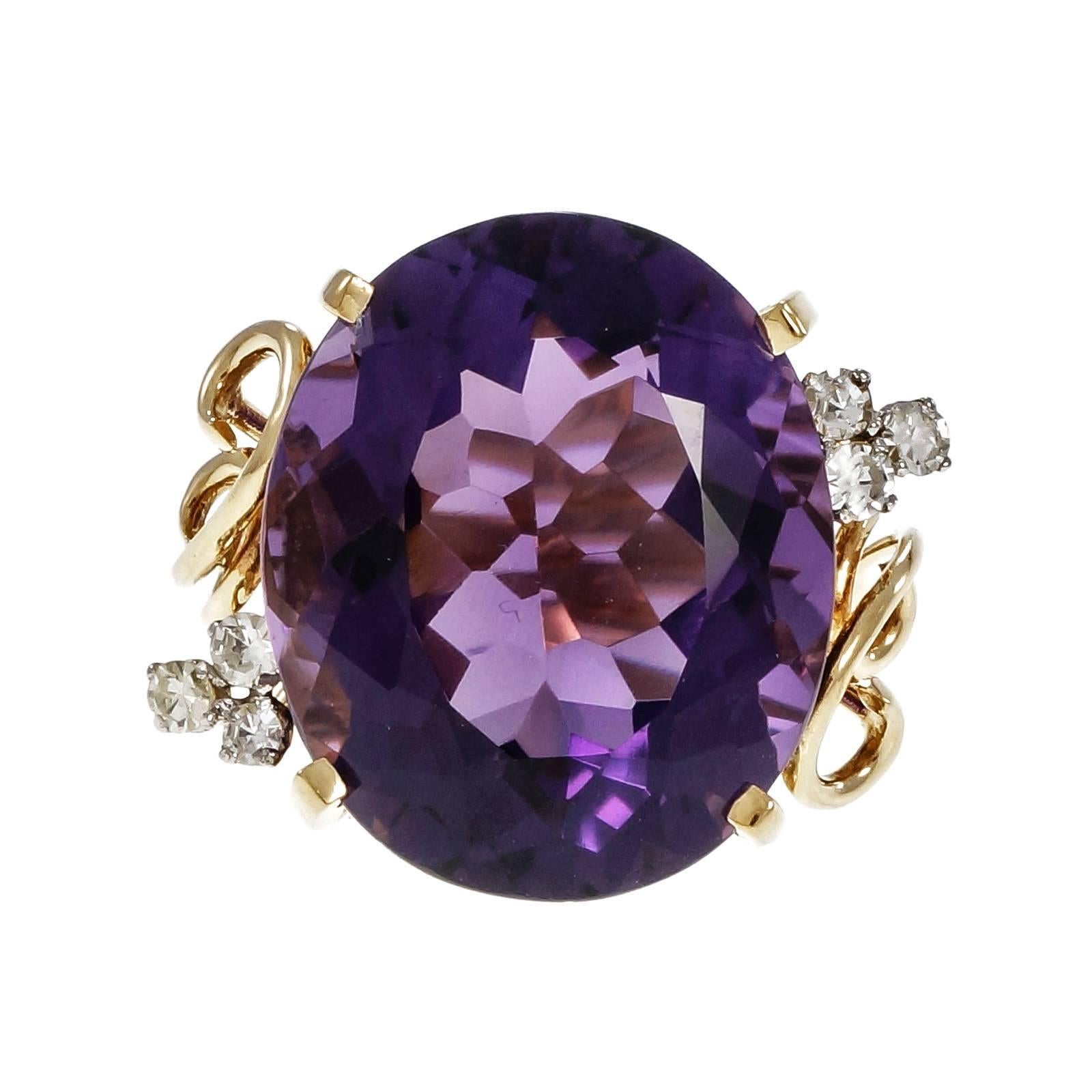 18k yellow gold 1950’s ring with a 20.00ct bright purple Amethyst and single cut diamond accents.

1 oval bright purple Amethyst, approx. total weight 20.00cts, VS, 19.10 x 15.92 x 9.87mm
6 round single cut diamonds, approx. total weight .24cts,