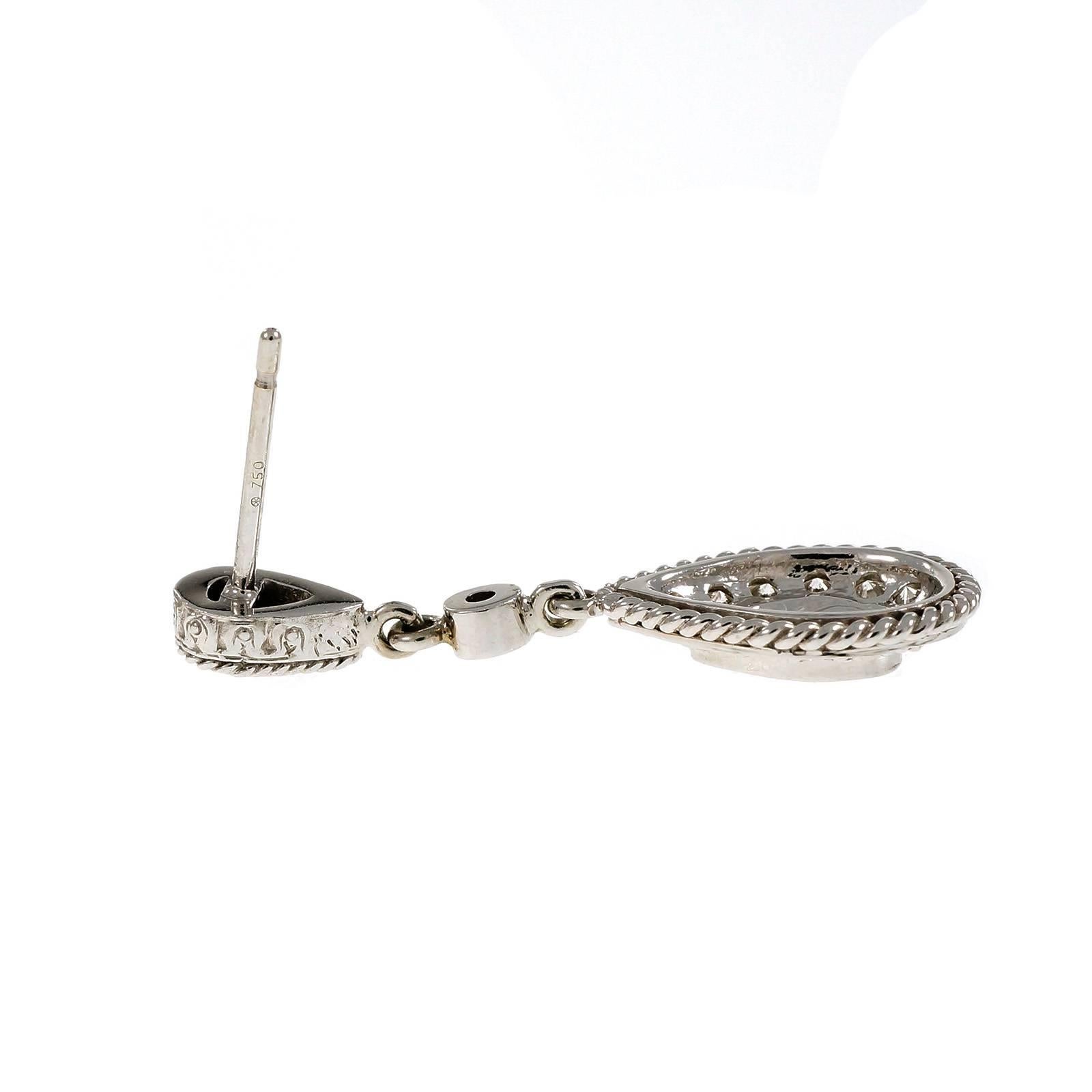 18k white gold dangle earring with bright full cut diamonds of excellent cut and sparkle.

4 round full cut diamonds, approx. total weight .08cts, G, VS
36 round full cut diamonds, approx. total weight .56cts, G, VS
2 round full cut diamonds,