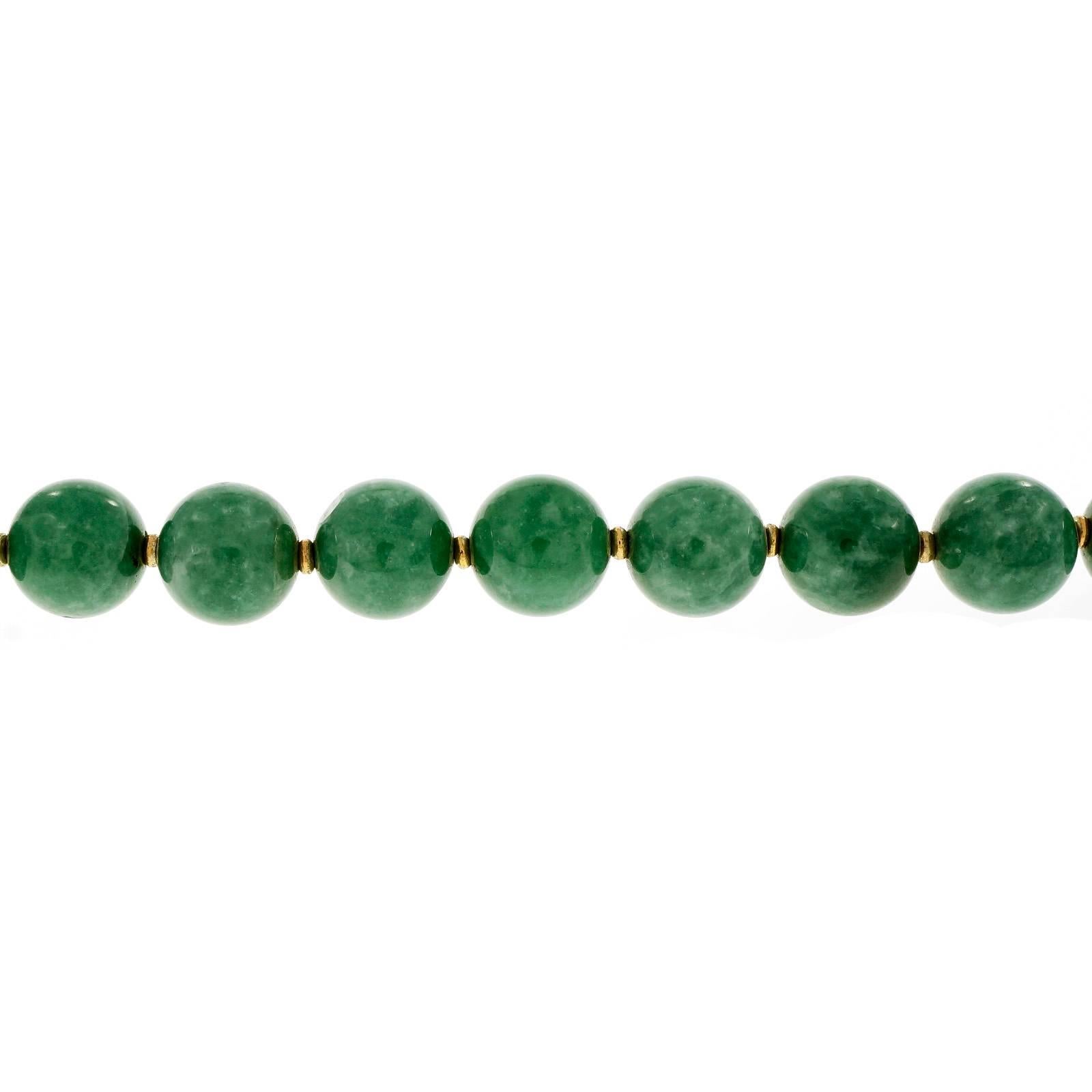 Large Jadeite Jade bead necklace GIA certified natural untreated no impregnated polymers. 14k gold spacers. Natural color variation. Full 20 inch length. Circa 1950.

1 oval cabochon Jadeite Jade, 16.0 x 11.66mm
33 round natural bead Jadeite