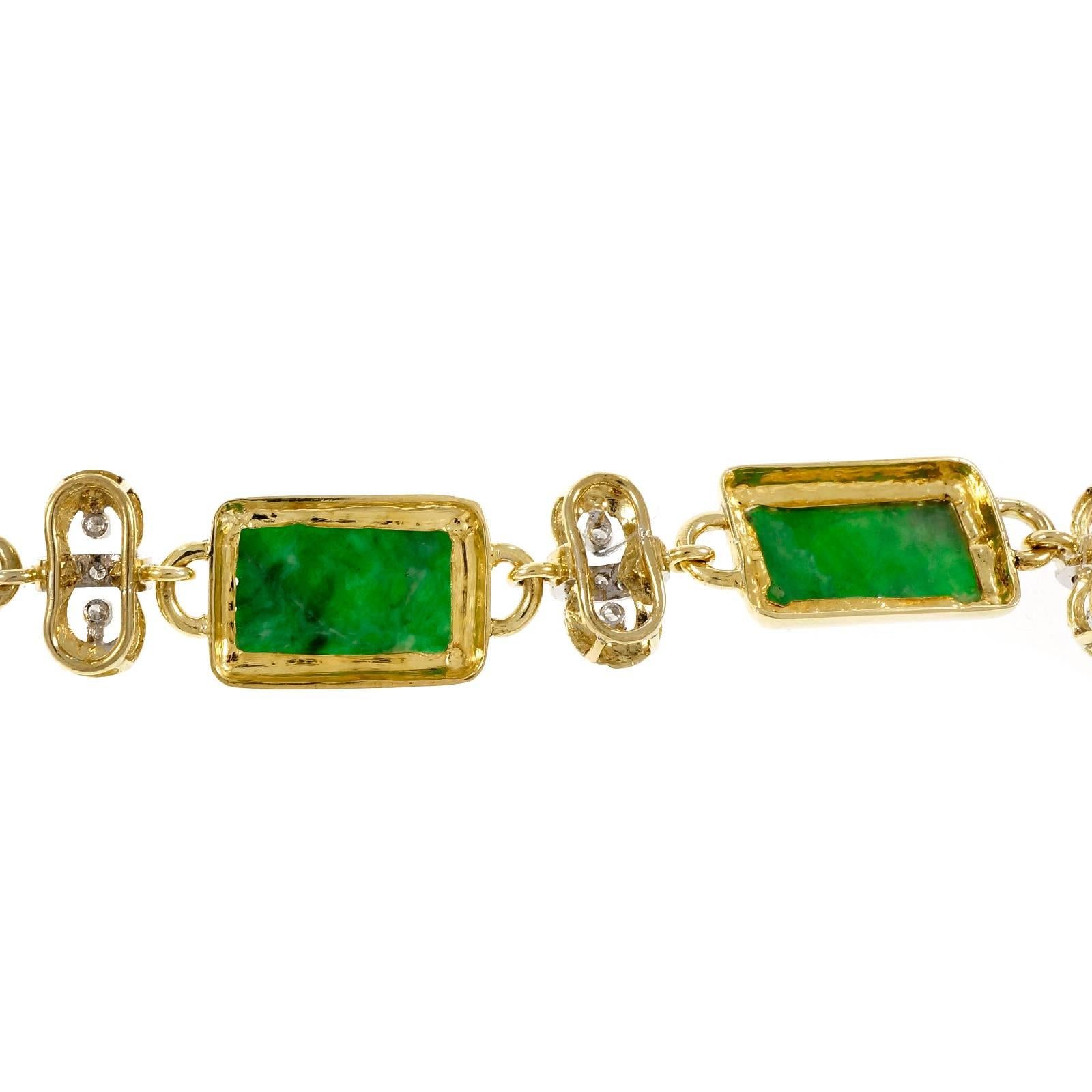 Natural GIA certified untreated Jadeite Jade translucent green 18k yellow and white gold bracelet circa 1950. Hidden built in catch with underside safety.

4 pierced carved green Jadeite Jade, 23.82 x 11.07mm, GIA certificate #2181005578
28 round