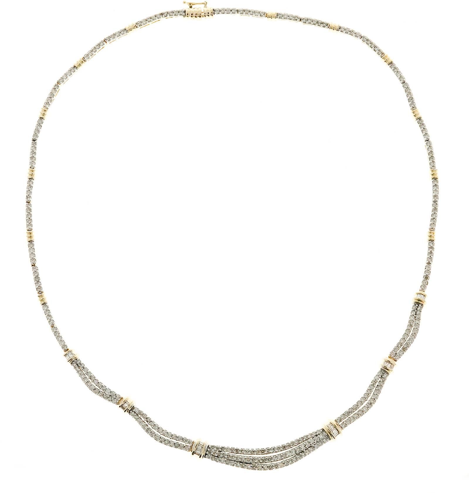 Three row diamond necklace. White gold diamond sections, yellow gold spacers.

327 round brilliant cut diamonds, approx. total weight 3.27cts, I, SI1 to I1
20 baguette cut diamonds, approx. total weight. 28cts, H - I, SI
14k White Gold
14k