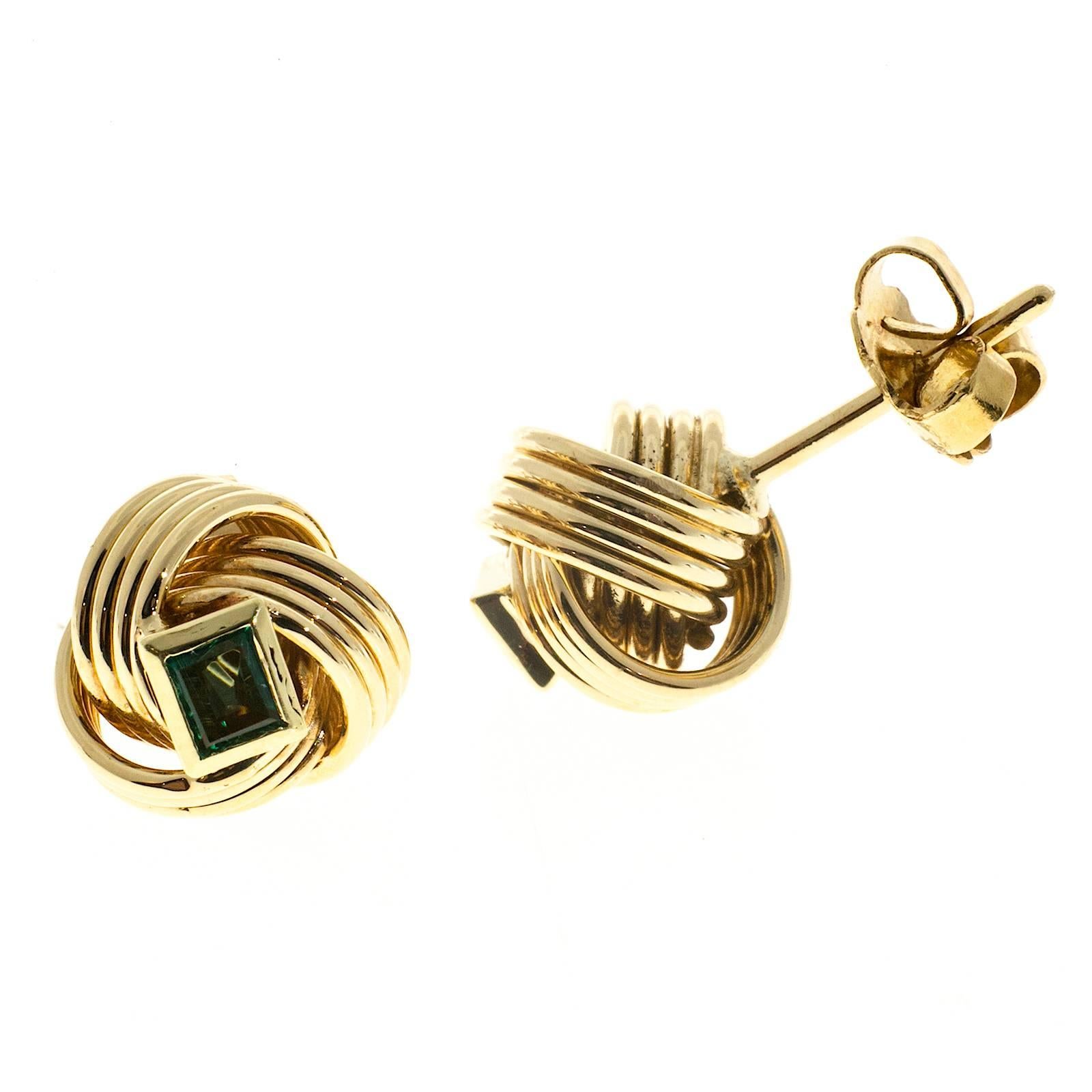 Handmade 18k yellow gold knot style earrings. 4 rows of round wire twisted into a 3 loop circle. The center of each is set with a bezel set rectangular top quality super bright and clear genuine emerald. 18k posts and earring backs. 

2