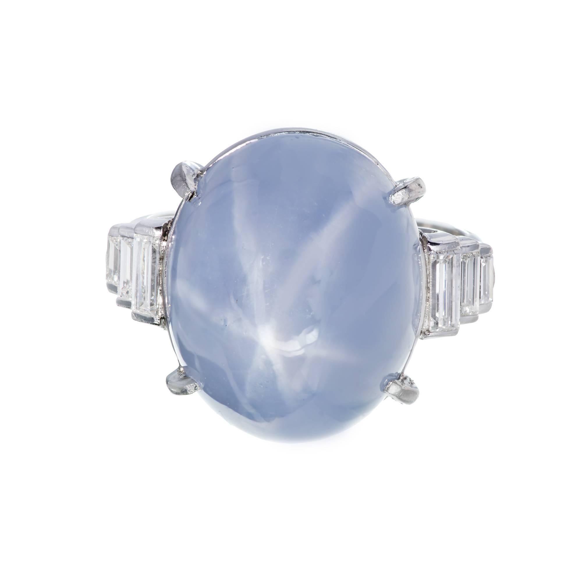Art Deco 1920’s star sapphire engagement ring. GIA certified medium blue high dome cabochon star sapphire with a distinct 6 legged star. Handmade platinum setting with 6 straight cut graduated baguette side diamonds. Natural color and untreated.
