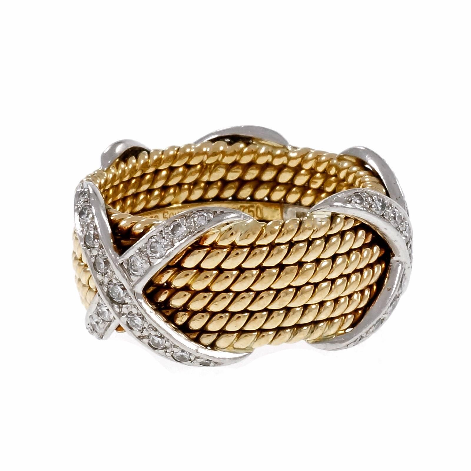 Tiffany & Co Schlumberger 6 row rope “X” ring in 18k yellow gold and platinum diamond Eternity. custom-made factory original size 8. Not sizable

51 round diamonds, approx. total weight .77cts
18k yellow gold & 950 Platinum
Tested: 18k
Stamped: