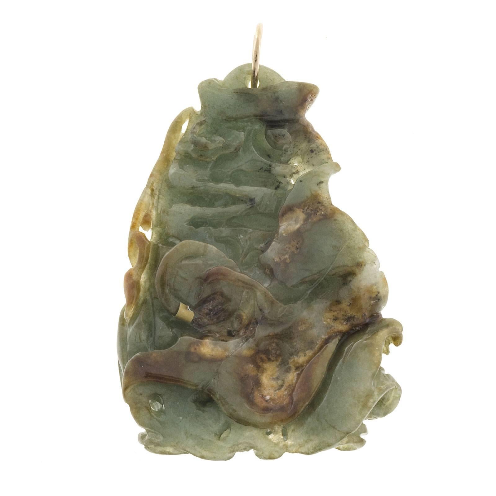 Untreated Jadeite Jade carved fish pendant. GIA certified natural and no impregnation. 14k gold pendant loop.

1 Jadeite Jade carving, approx. total weight 156.16cts, 55.45 x 39.13 x 13.63mm, variegated green brown and white translucent, natural