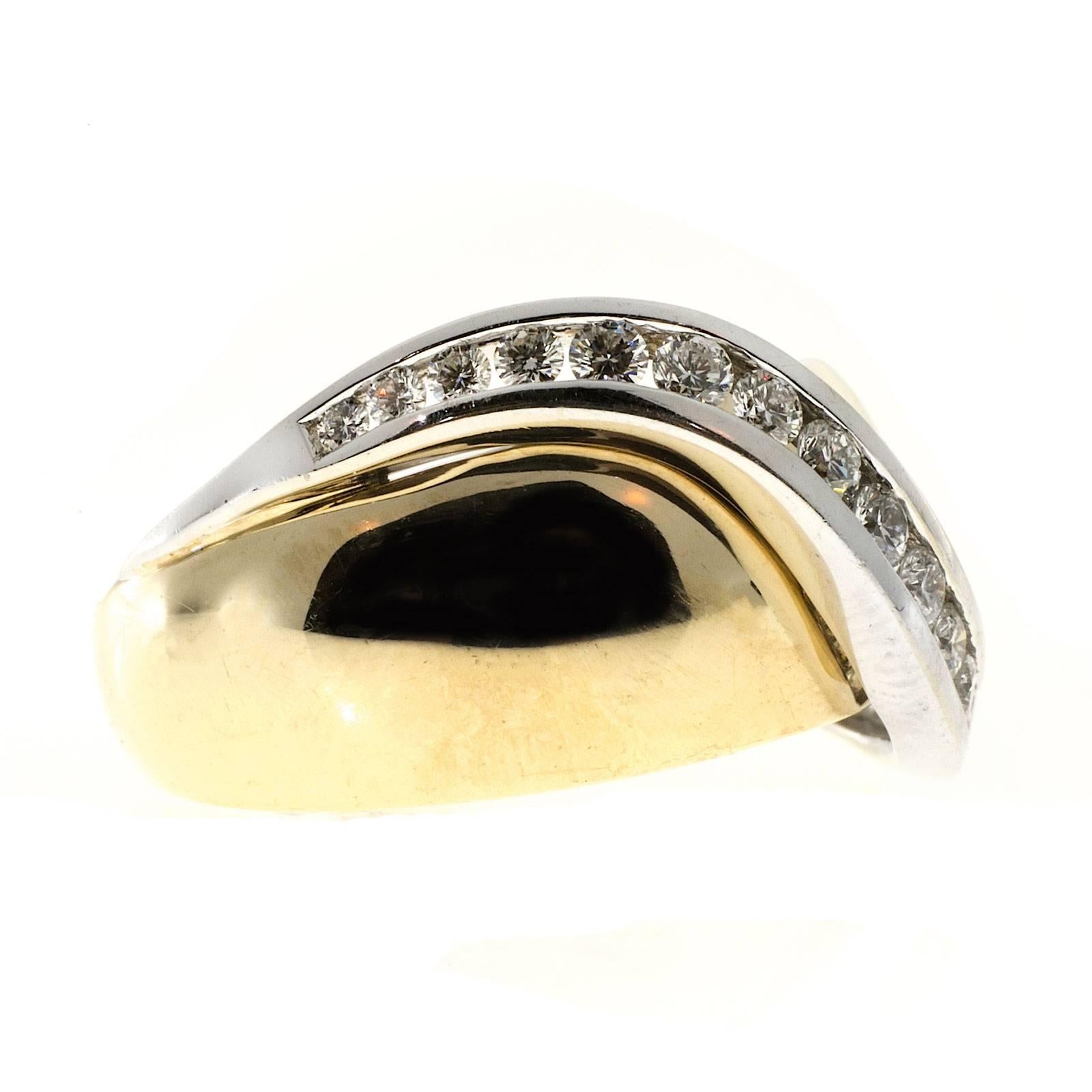 Solid 14k yellow gold tapered band with white gold channel set swirl of full cut diamonds. From the designer JME.

17 round diamonds approx. total weight .50cts, F, VS
14k Yellow Gold
Stamped JME 585=14k
11.6 grams
5/8 x 7/8 inch
Size 6 ¾ and