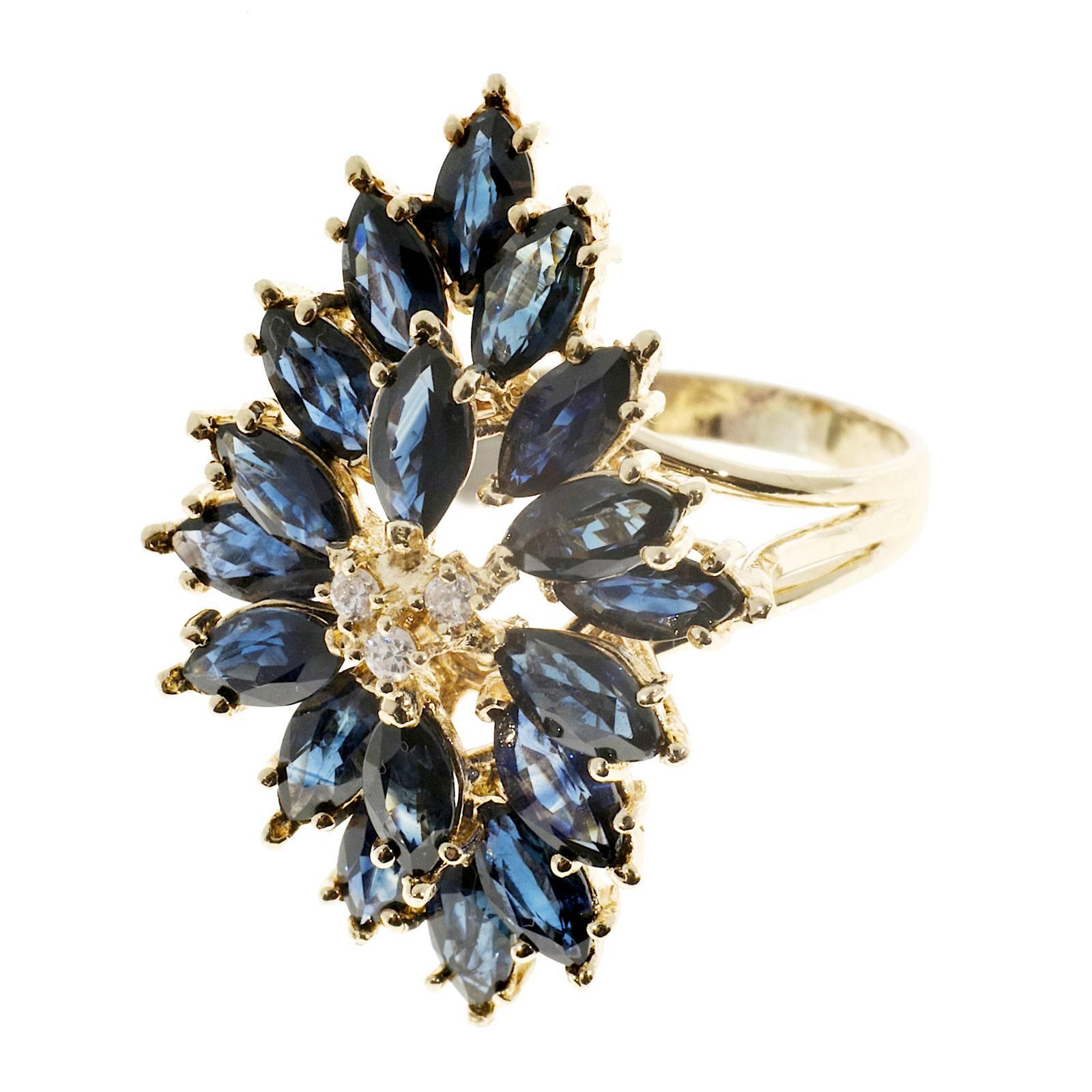 Large handmade 14k gold wire constructed Sapphire and diamond ring. Bright deep blue genuine Sapphires.

3 full cut diamonds approx. total weight .05cts, G, VS
18 genuine Marquise Sapphires 6 x 3mm, approx. total weight 6.00cts
14k Yellow