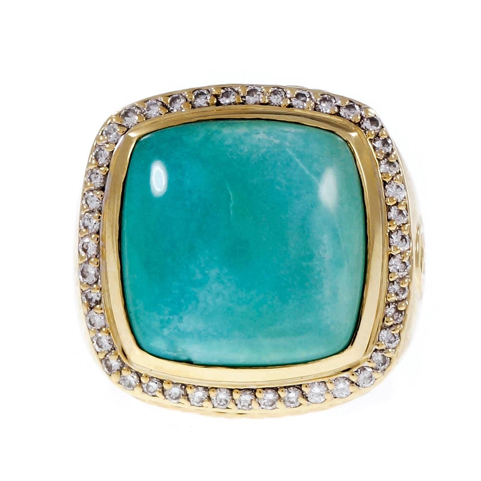 David Yurman solid 18k yellow gold Albion ring with a rim of bright white full cut diamonds surrounding a natural Turquoise.

44 round full cut diamonds, approx. total weight .30cts, H, VS – SI
1 cushion cabochon blue Turquoise 15 x 15mm
18k yellow