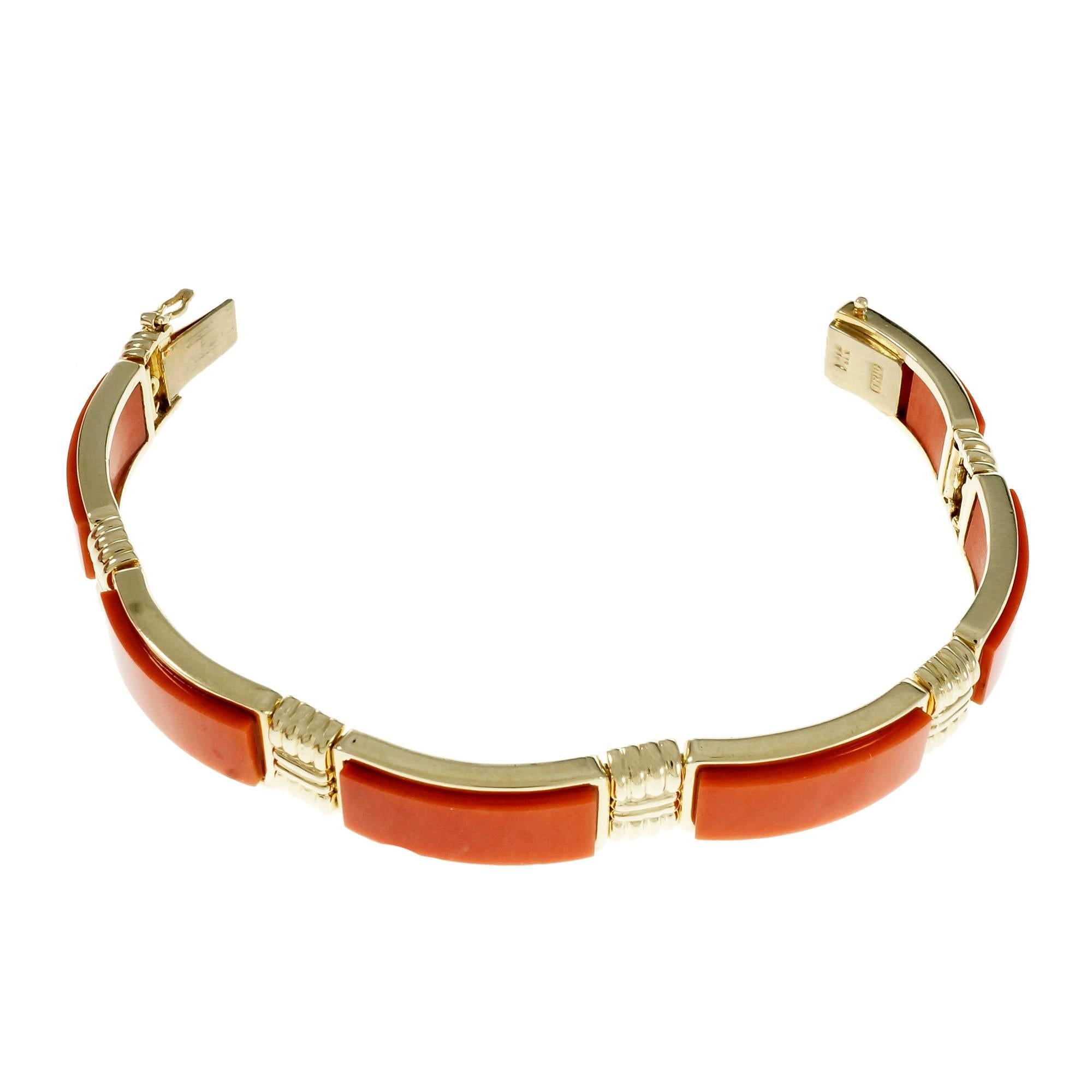 Wonderful natural Coral GIA certified pink orange Trio semi bangle bracelet circa 1960.

6 carved rectangular tablet pinkish orange Coral, GIA certificate #2185072071
14k yellow gold
Tested and stamped: 14k
Hallmark: Trio
32.4 grams
Length: 6.5