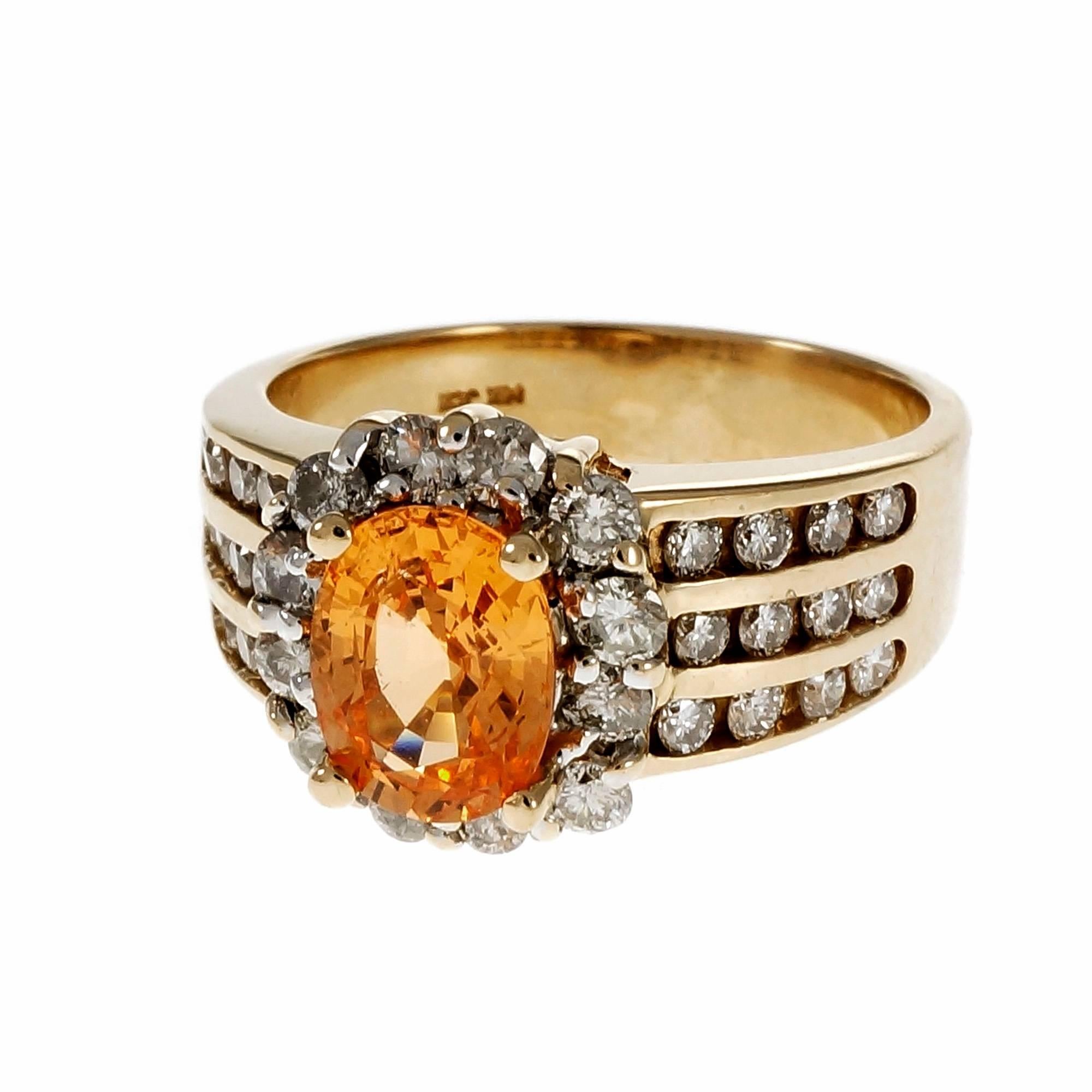 Estate bright orange Spessartite Garnet with a diamond halo and three rows of Diamonds on each side in a 14k yellow gold setting. 

1 oval Spessartite orange Garnet, approx. total weight 1.81cts, VS
36 round full cut Diamonds, approx. total weight