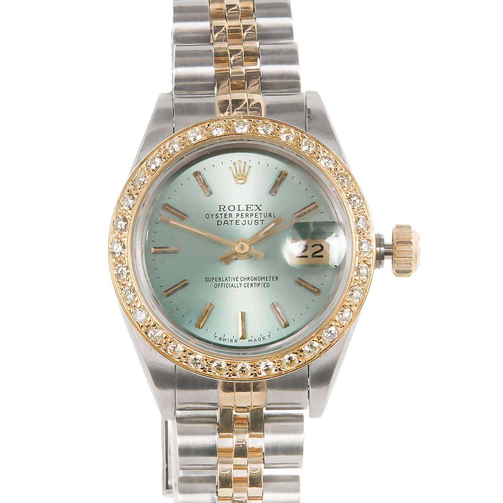 Ladies 14k gold and steel Rolex Datejust 69173 with custom colored light blue green dial and custom diamond bezel. Original Rolex Jubilee band.

31 round diamonds approx. 1.00cts G, VS-SI
14k yellow gold and steel
Length: 7.25 inches
57.0