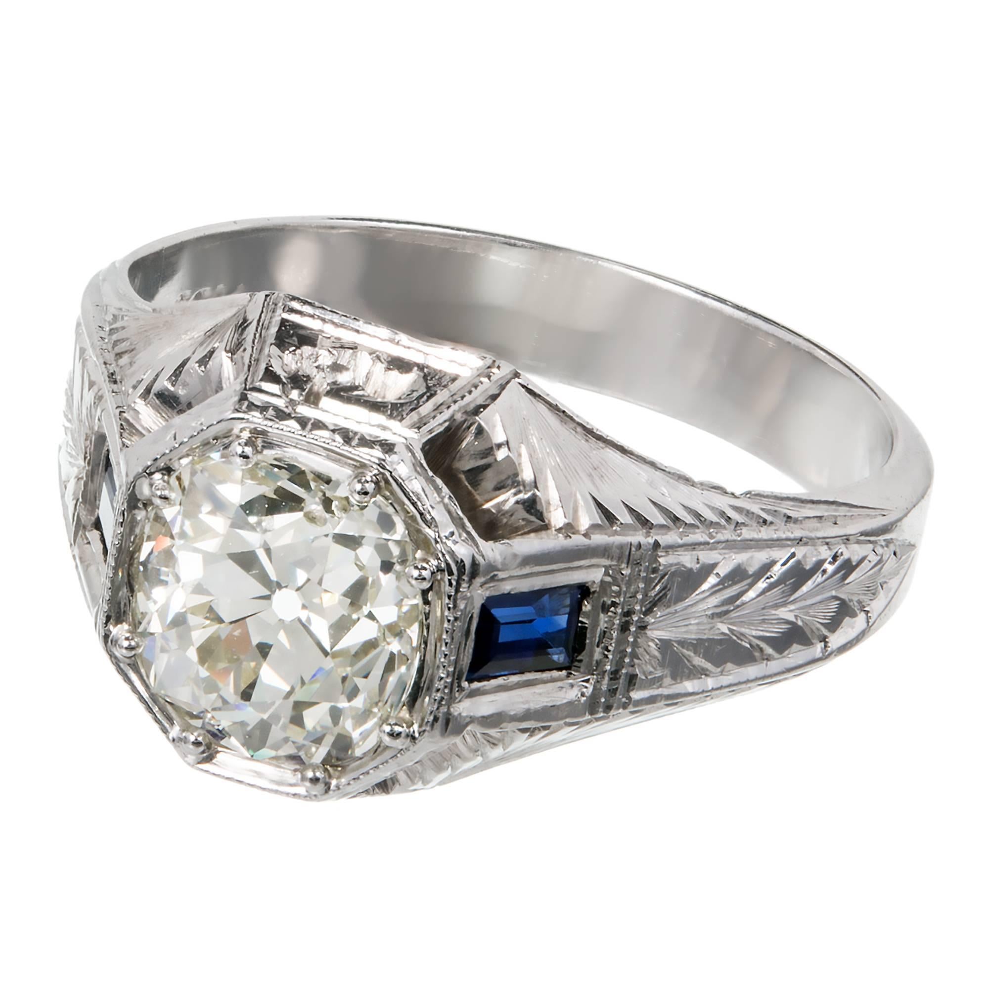 GIA certified raised crown diamond men's ring in a 20k white gold setting with sapphire accents. Circa 1920-1930. The sides are cut out allow light for diamond to sparkle. Hand engraved shank. 

1 Old Mine Brilliant Diamond 1.92 cts 54% table 78.2%