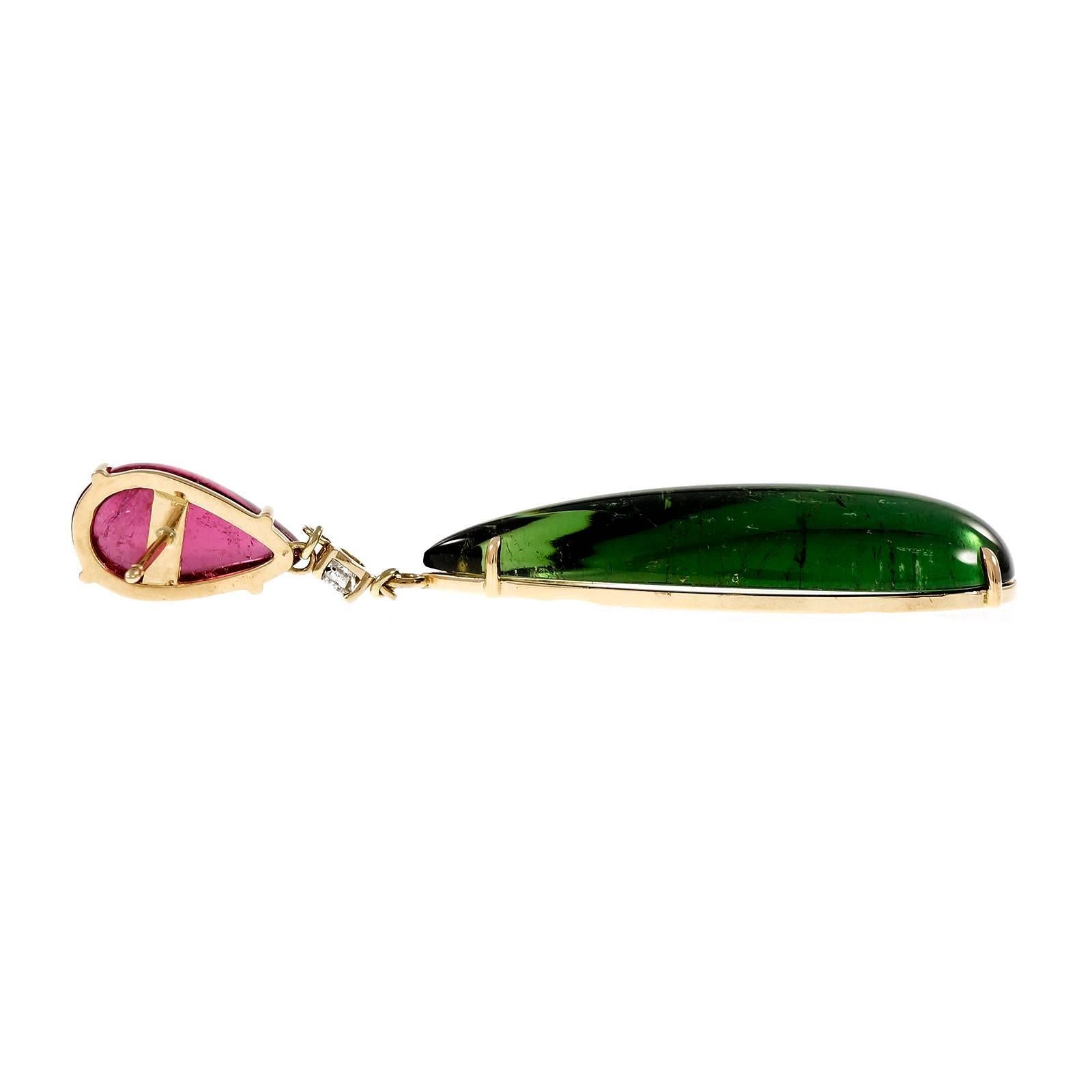 Tourmaline and diamond dangle earrings. Two beautiful elongated pear shaped cabochon green tourmalines totaling 63.41 carats mounted in 18k yellow gold settings with 2 pear shaped pink cabochon tourmalines totaling 13.23cts. Two round cut diamonds