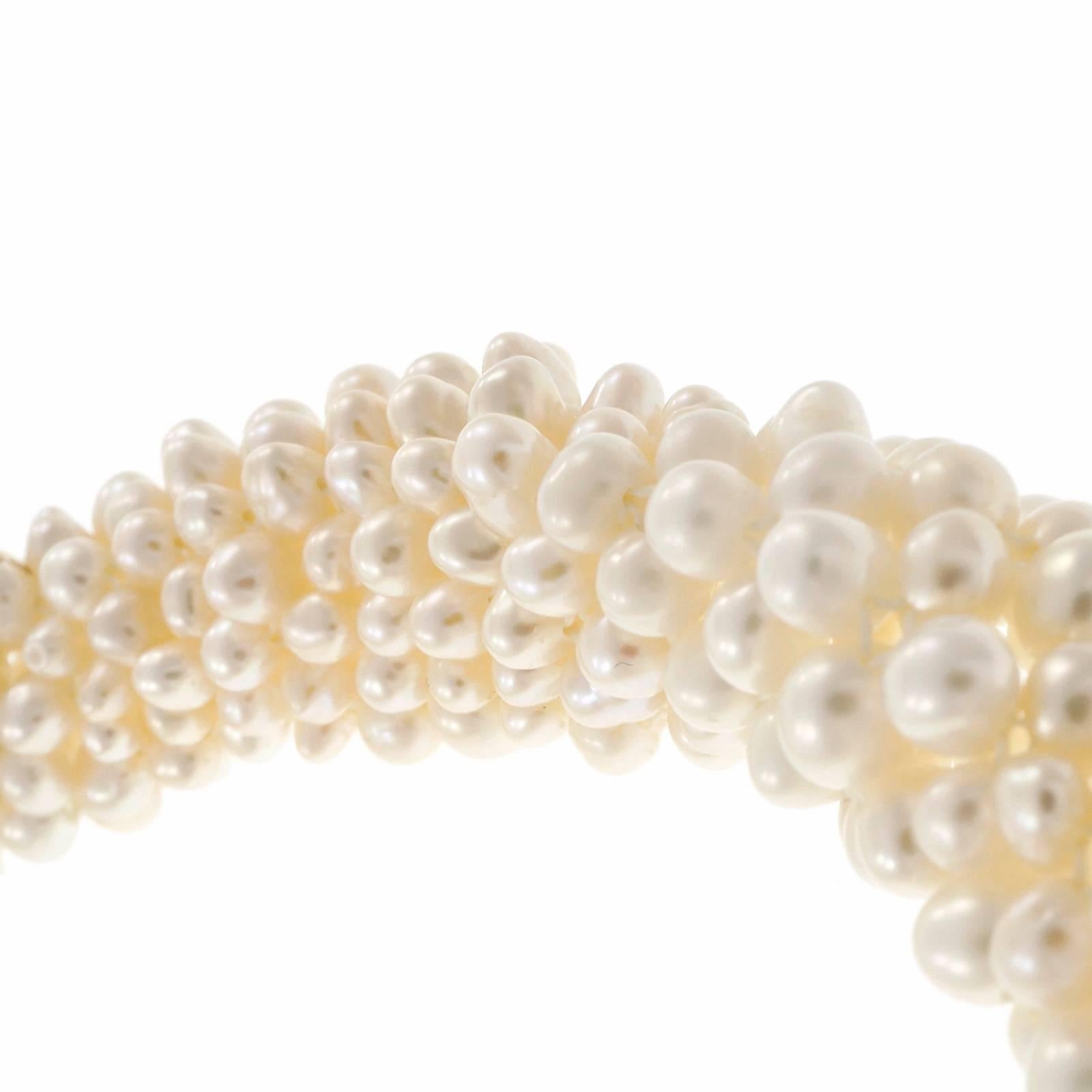 Spectacular Freshwater cultured pearl round and diamond necklace. Set with approximately 1,300 pearls, accented by60 round 14k yellow gold beads and 54 round cut diamonds. 16.5 inches in length with a 14k yellow gold textured clasp. 

14k two-tone