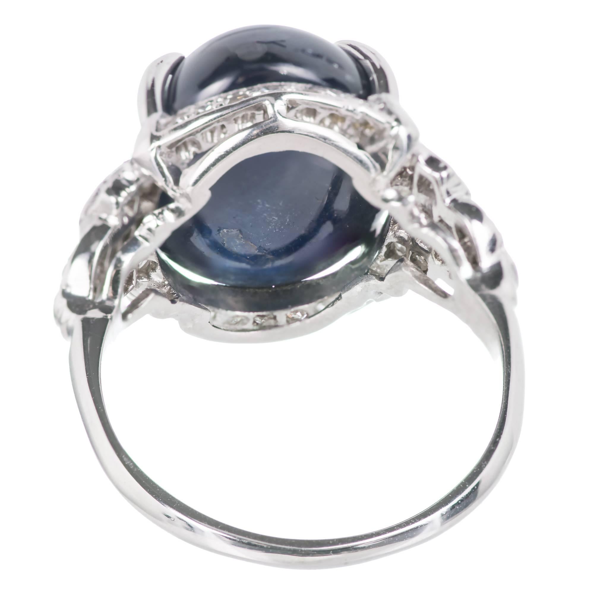 Art Deco 1920's Sapphire and diamond platinum engagement ring set with Emerald cut and round cut diamonds that surround a deep Royal blue semitransparent cabochon Sapphire approx 12.13 ct. GIA certified, CMG 1 origin, natural sapphire, simple low