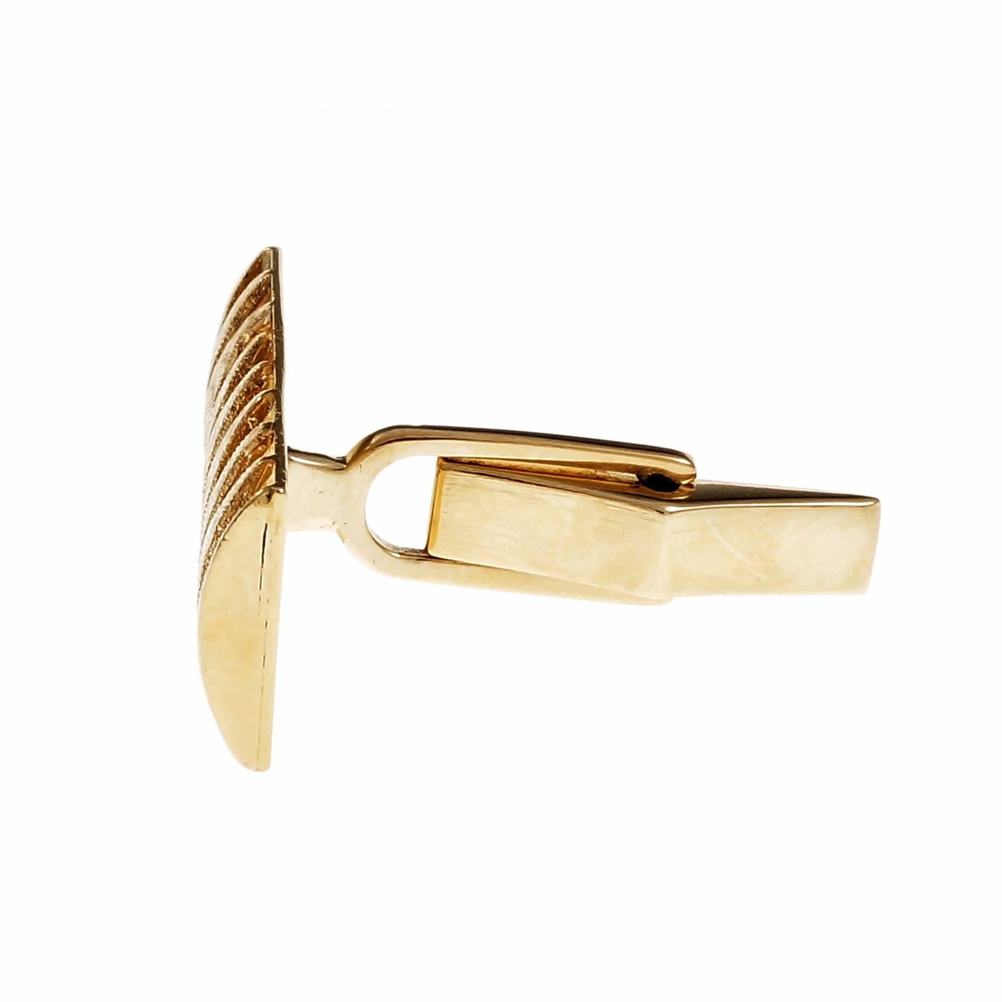 1950 hand textured two-dimensional rectangular clip back cufflinks.

14k yellow gold
Tested and stamped: 14k
Hallmark: MJ R
10.1 grams
Top to bottom: 11.7mm or .46 inch
Width: 24.20mm or .95 inch
Depth: 3.11mm
