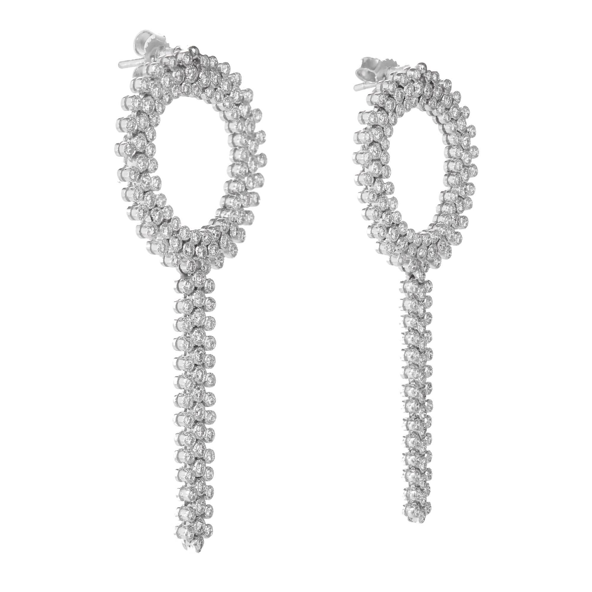 1960’s dangle earrings with individual tube set diamonds hinged together to form a circle with a tassel dangle. Soft flowing movement. 

254 round full cut diamonds G VS2 SI approximately 1.40 carat
8.7 Grams
14k White Gold
Tested: 14k
Earring backs