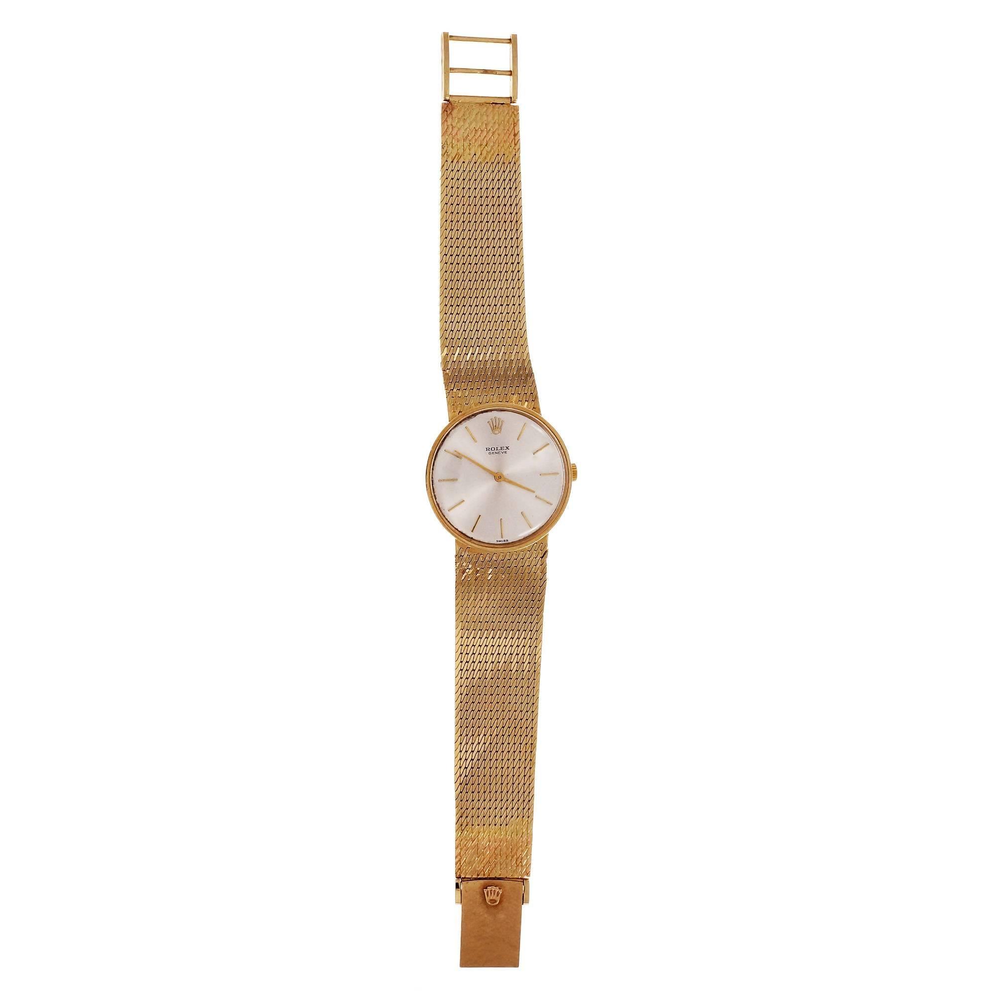 Rolex solid 14k gold dress watch circa 1960 with manual wind 17 jewel Rolex movement and mesh watch band attached. Extenders have been put on both ends of the mesh band to lengthen it to 7 1/8 inches. Hand engraving blends in the extenders well from