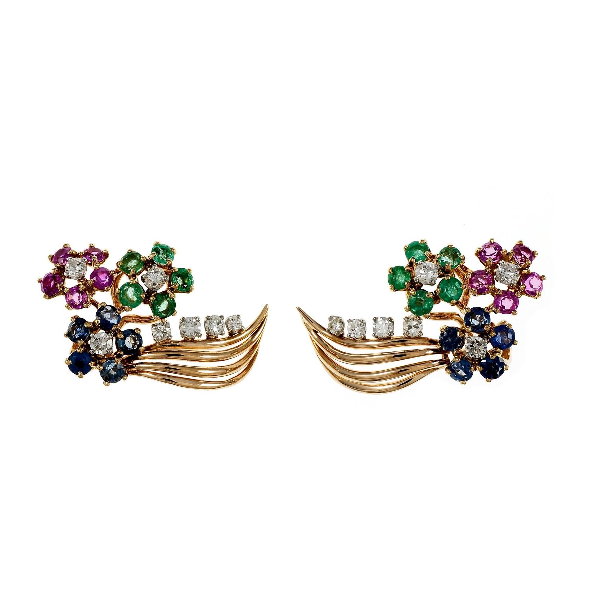 1940-1950 vintage clip post flower design earrings in 14k gold with genuine Emeralds, Rubies, Sapphires and Diamonds.

14 round full cut Diamonds, approx. total weight .60cts, H – I, VS
10 pinkish red genuine Rubies, approx. total weight 1.15cts,
