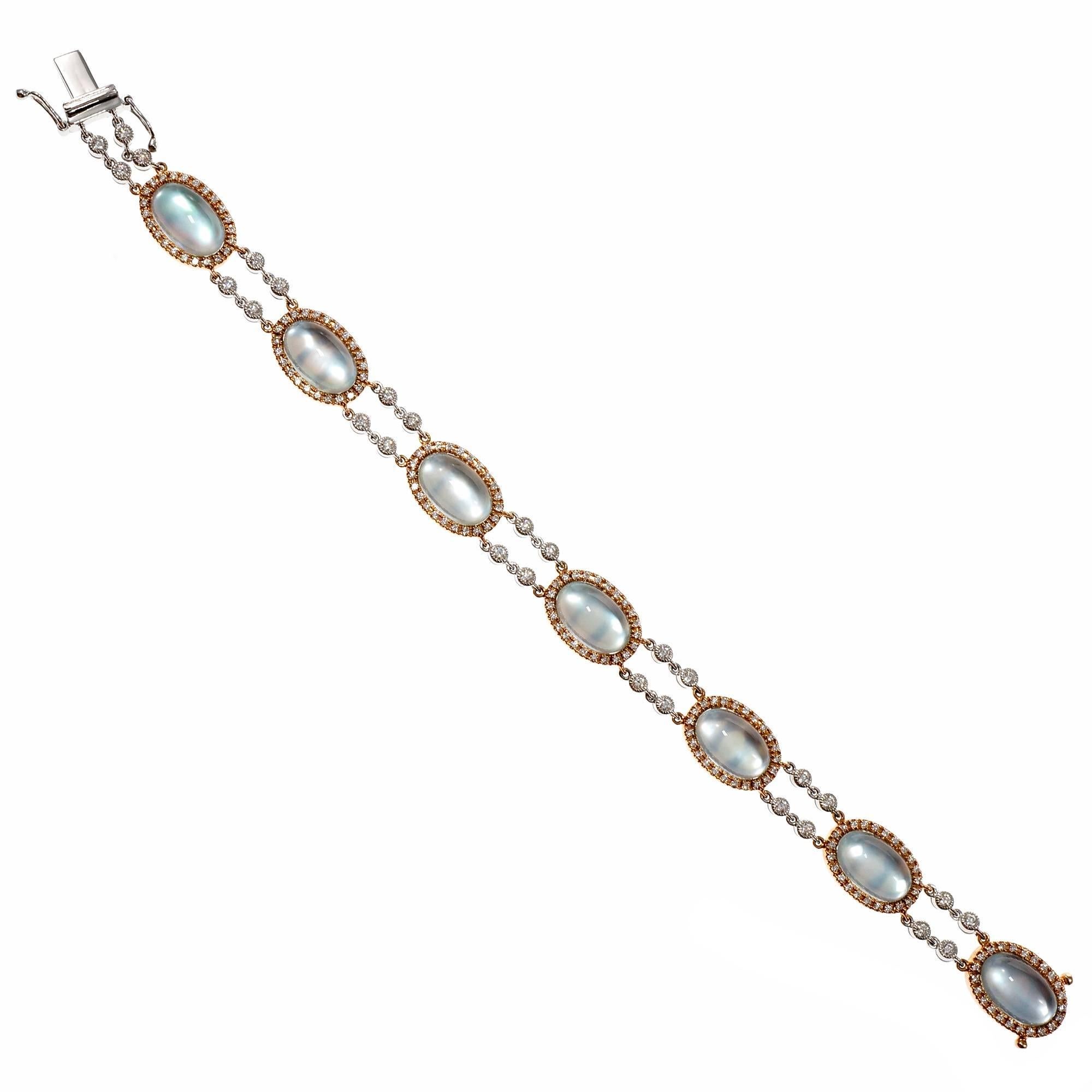 Designer JMP blue Topaz cabochon rose and white gold bracelet with  Diamond accents. The blue Topaz mounted on Mother of Pearl has a blue glow. Set in rose and white gold. 

189 round full cut Diamonds, approx. total weight 1.44cts, G – H, VS1 –