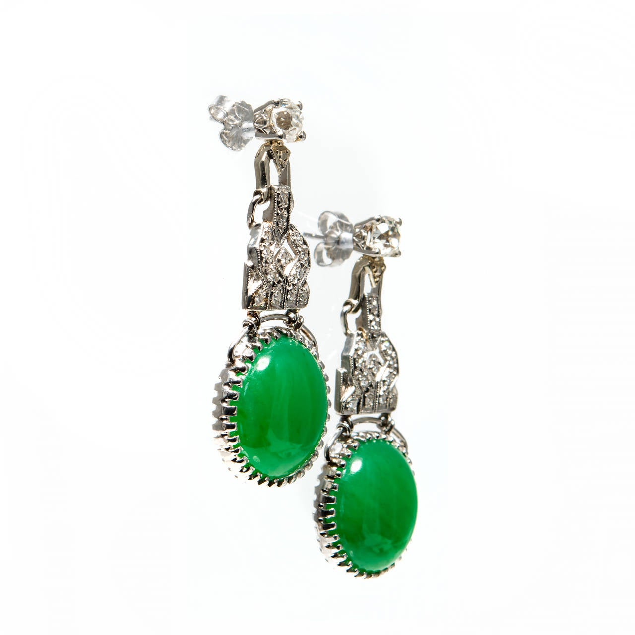 Jade and diamond dangle earrings set in handmade platinum.  Well cut old mine diamonds on the top with pave accent diamonds. Certified natural untreated undyed green Jadeite Jade drops.  Each one is GIA certified.     

1 round cabochon cut Jadeite