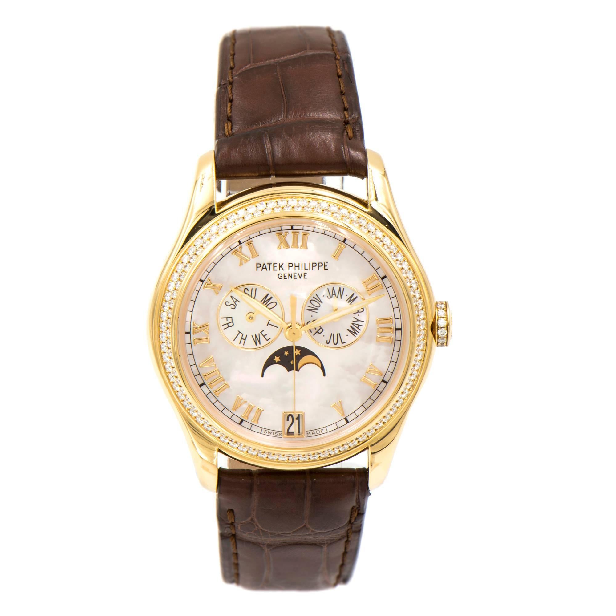 Ladies Patek Philippe diamond wrist watch. Moon phase day date month automatic. Mother of Pearl dial. 18k Yellow gold.  New Patek band. 18k Patek buckle.

Length: 44mm
Width: 37mm
Band with at case: 19.0mm
Case Thickness: 11.3mm
Band: Brand new