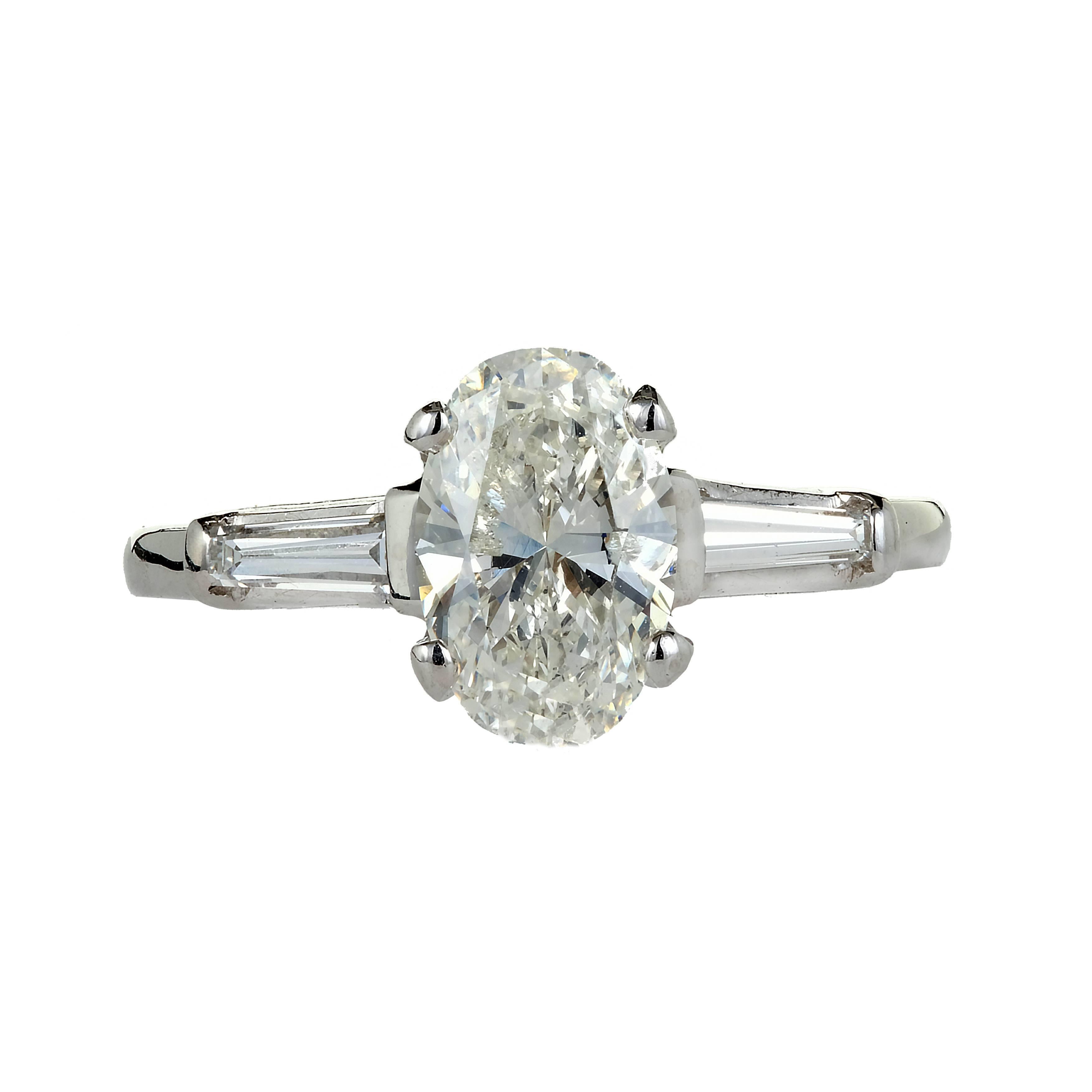 Vintage original 1950 mid-century classic three-stone diamond engagement ring with a bright sparkly oval Diamond flanked by tapered baguette Diamonds in a Platinum setting.

1 oval Diamond, approx. total weight 1.38cts, I – J, I1, EGL certificate