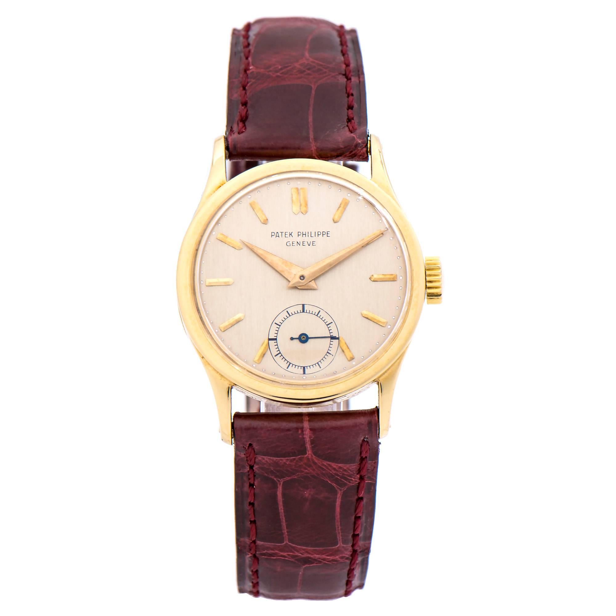 Patek Philippe Calatrava 18k Yellow Gold wristwatch with original dial and hands with laped yellow gold indexes and subsidiary seconds dial at 6 o'clock. Domed acrylic crystal. New unworn Patek Philippe band and 18k yellow gold buckle. 

Calibre