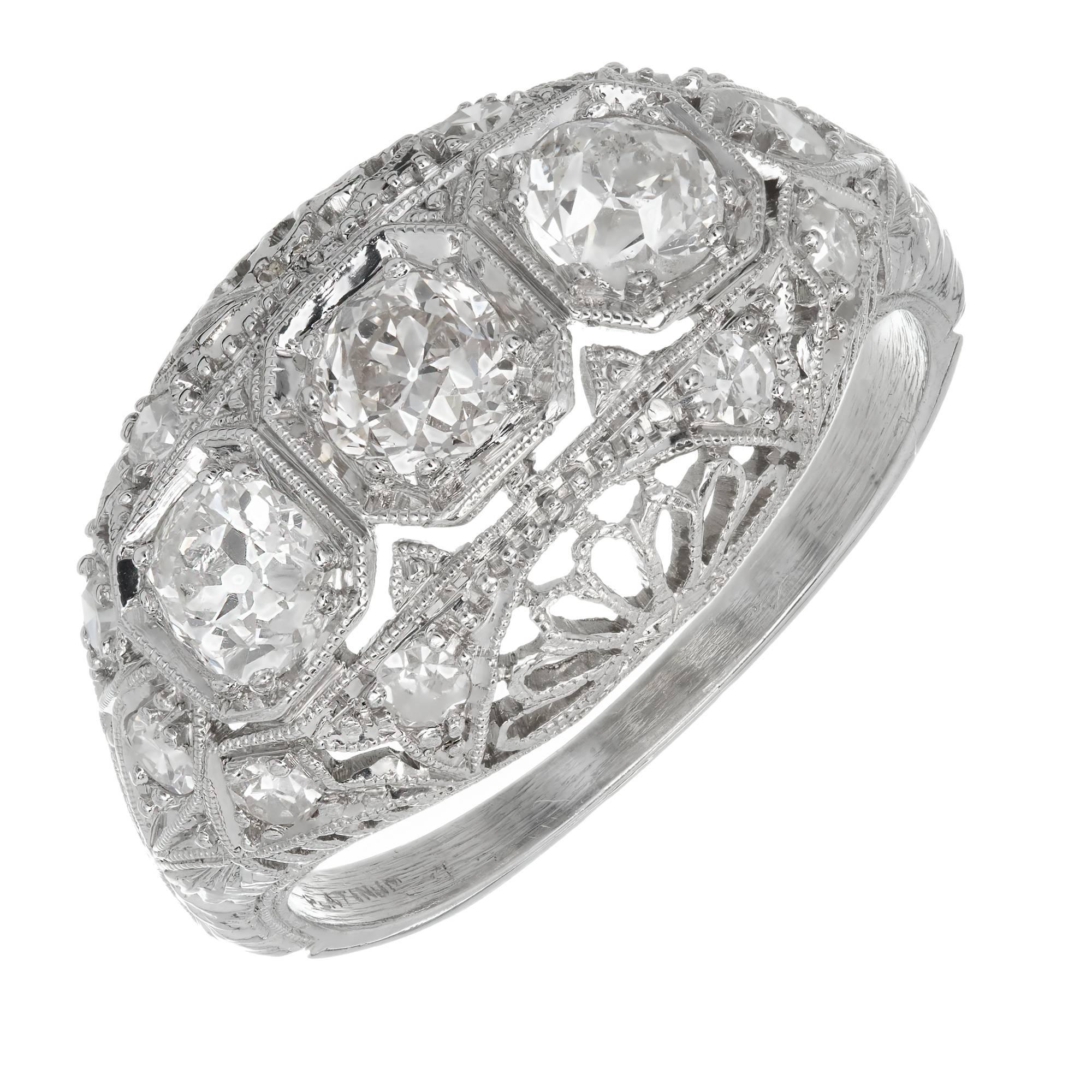 Vintage 1930 filigree dome engagement three-stone ring in Platinum with old European and single cut Diamonds.

3 old European cut Diamonds, approx. total weight .75cts, H – I, SI1
10 single cut Diamonds, approx. total weight .20cts, H – I,