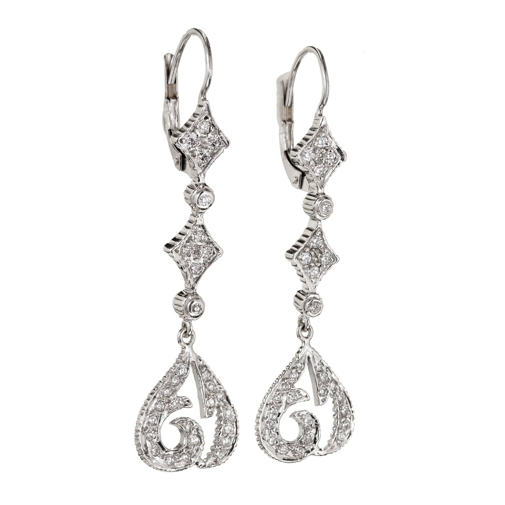 Doris Panos 18k white gold dangle earrings with secure wire tops and a long dramatic design with sparkly diamonds

60 round full cut diamonds, approx. total weight .70cts, F, VS2
18k White Gold
Tested: 18k
Stamped: 750
Hallmark: DP 2004
5.7