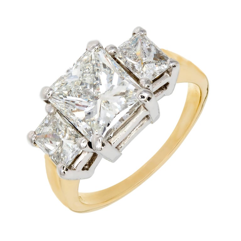  Peter Suchy Radiant cut Diamond three-stone engagement ring with bright sparkly radiant cut Diamonds in a classic 18k yellow gold and Platinum secure and low to the finger, setting. GIA certified 2.23ct center Diamond with strong blue florescence