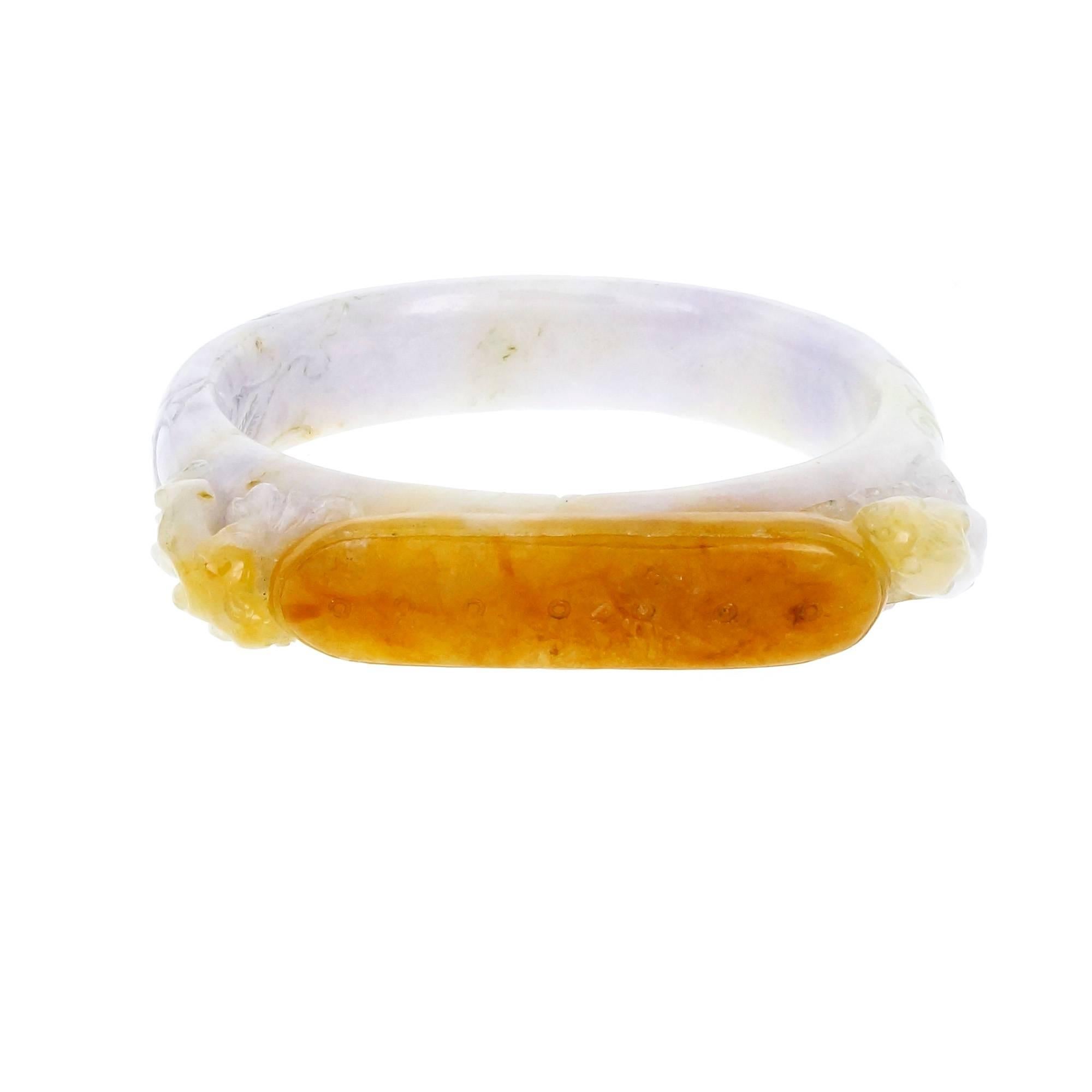 Natural Jadeite Jade GIA certified saddle style bangle bracelet. Variegated brown and purple color, carved animals and center plaque. Inside circumference 6.5 inches, will fit over a small hand.

1 variegated brown and purple Jadeite Jade bangle