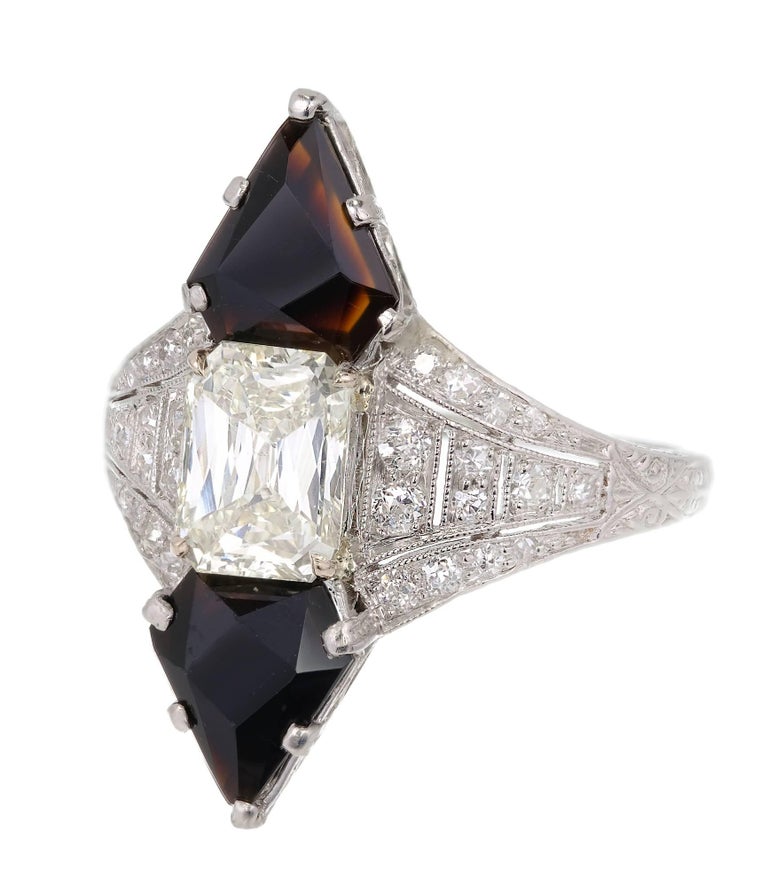 Art Deco Black Star & Frost Calibré cut black Onyx and Emerald step cut center diamond in a platinum setting with accent diamonds. 

1 Emerald step cut diamond, approx. total weight 1.03cts, M – N, SI1, EGL certificate # US312362301D
28 round