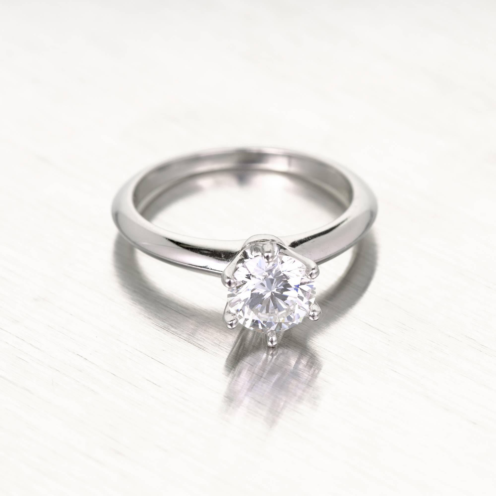 Tiffany & Co diamond solitaire engagement ring in a platinum setting. 1980-1990 stamped authentic Tiffany Platinum engagement ring.  GIA certified diamond. The diamond was removed for GIA certificate # testing and reset. 

1 round Ideal cut diamond,