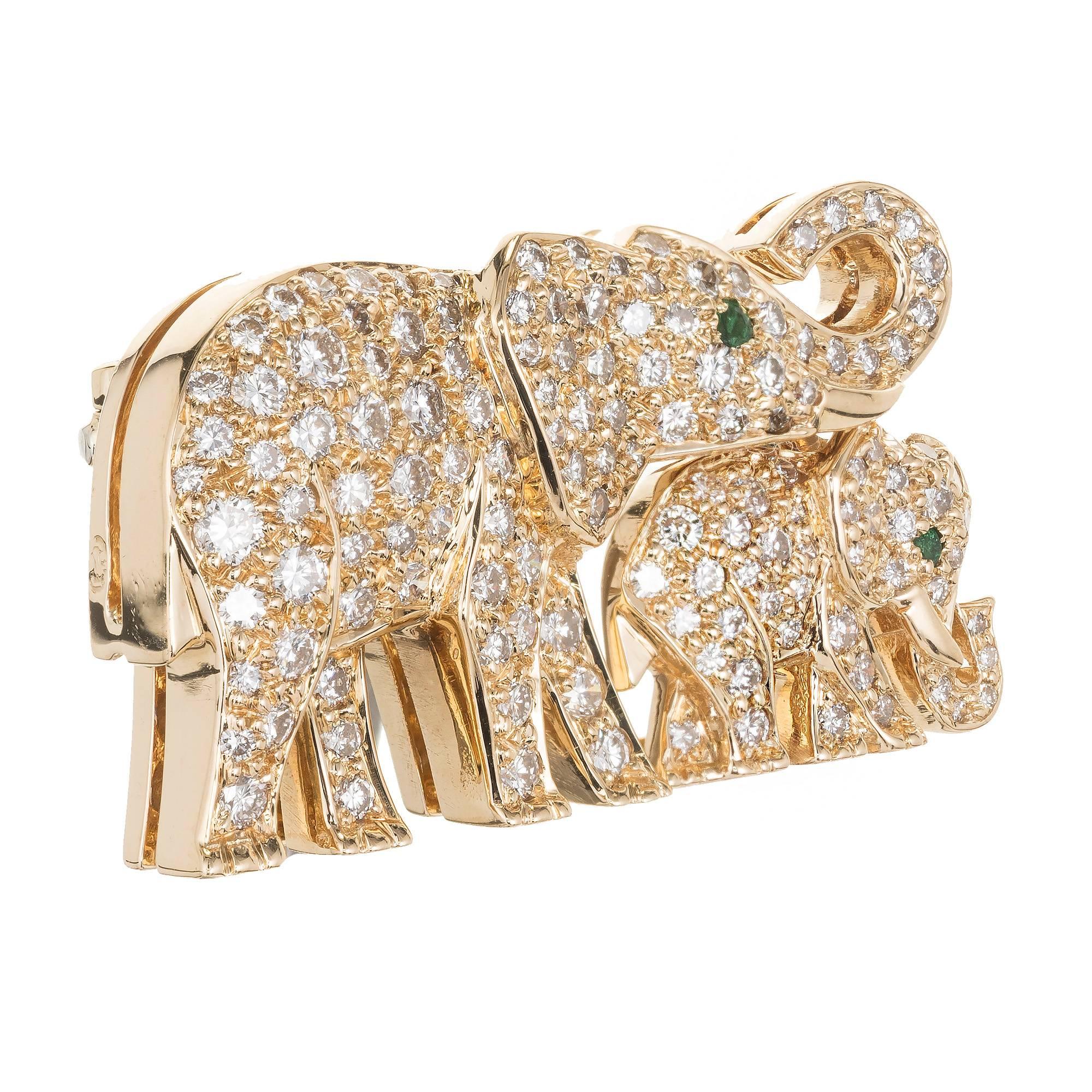 Cartier  Mother and Child Elephant Brooch pin in solid 18k yellow gold with pave diamonds and genuine emerald eyes.

Approximately 129 round full cut diamonds FG-VS 1.20 carats
Two green emerald eyes VS-SI
Top to Bottom: 16.91mm or .66 inches
Width:
