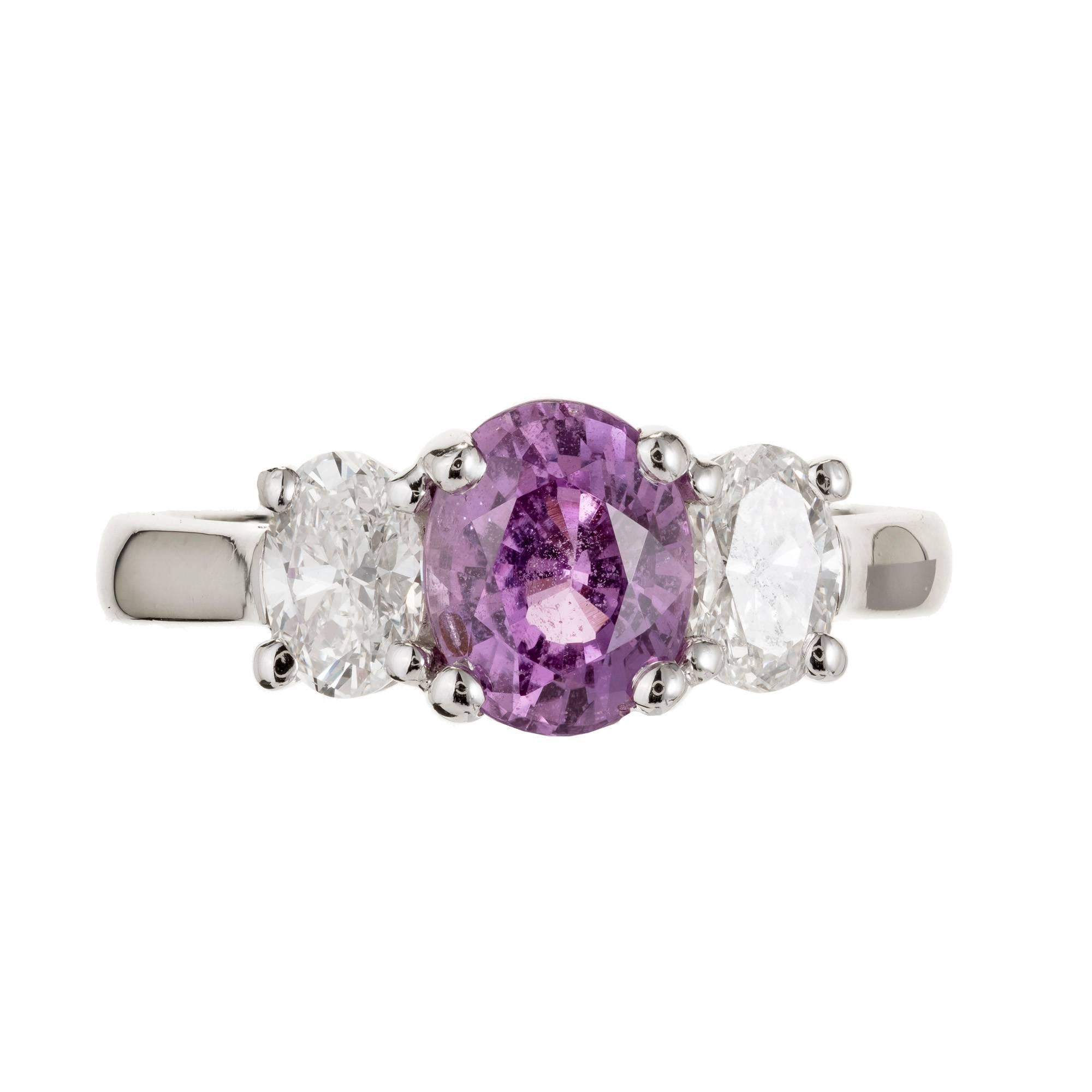Peter Suchy natural no heat GIA certified purplish pink oval Sapphire set in a three-stone platinum setting with two oval side diamonds. 

Platinum
1 oval purplish pink Sapphire, approx. total weight 1.82cts, 7.99 x 6.35 x 4.43mm, GIA certificate