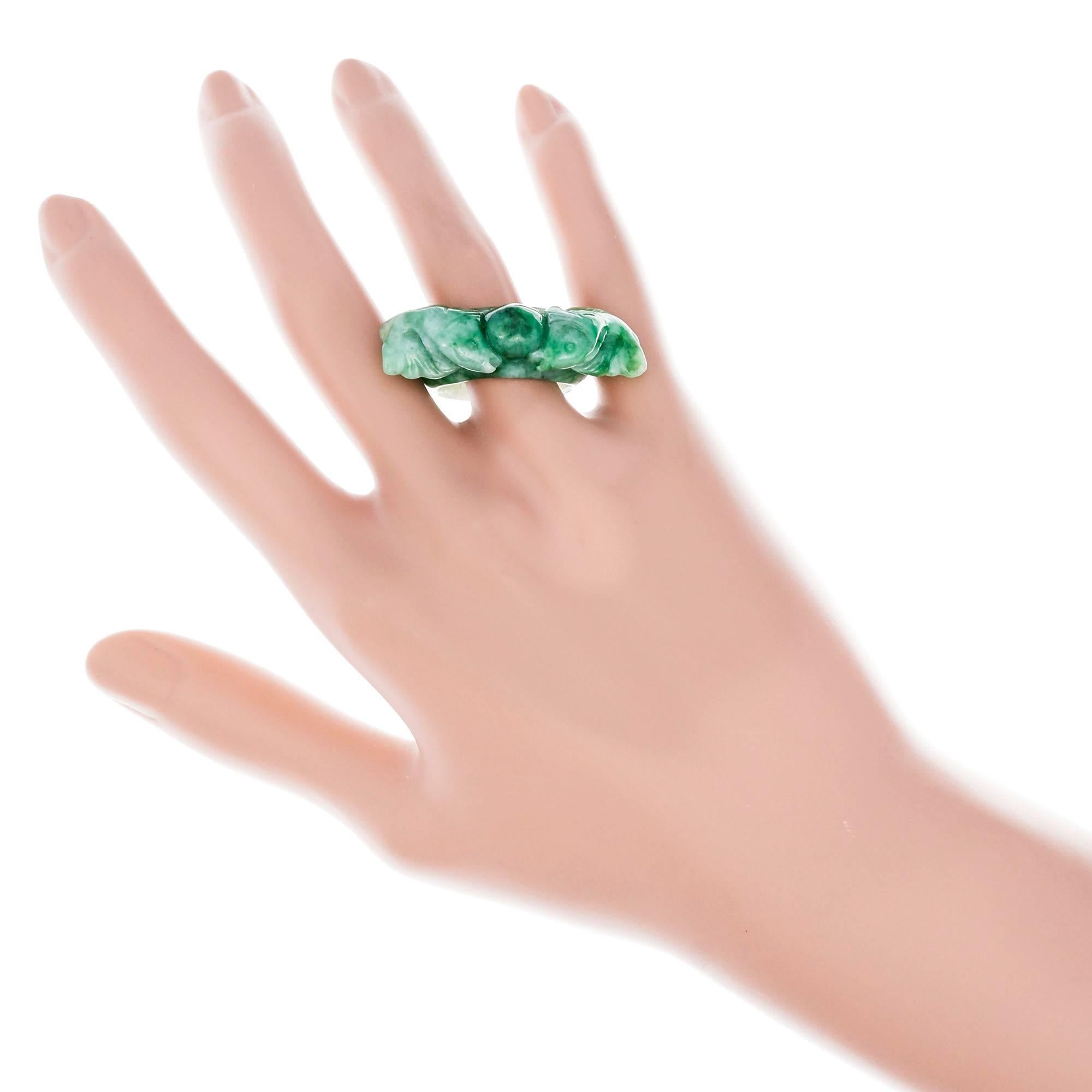 Natural bright mottled or blended green double fish Jadeite Jade across the finger ring. GIA certified natural untreated Jadeite Jade. 

1 carved mottle green translucent Jadeite Jade, approx. total weight 10.57cts, GIA certificate #2185600510
Width