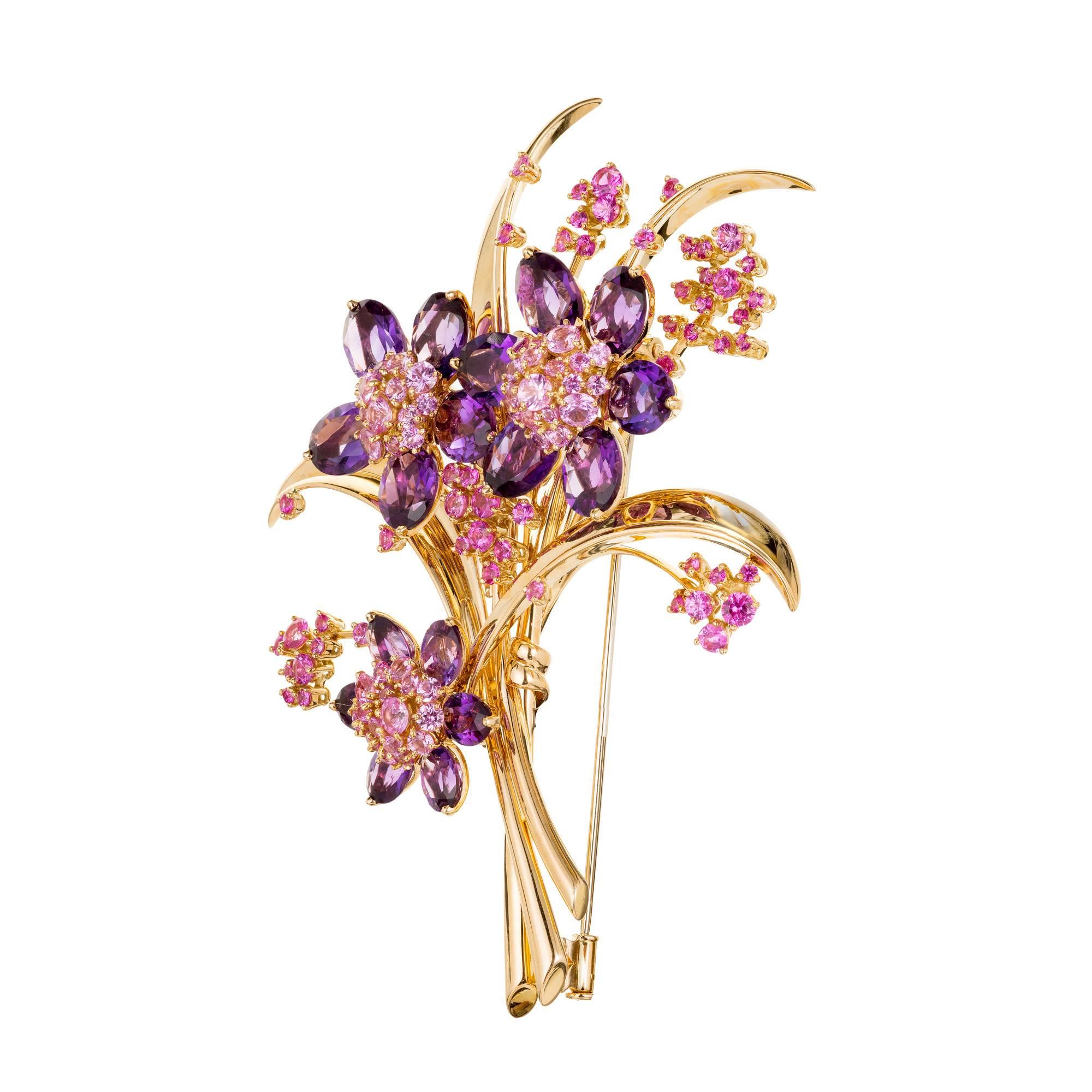 Van Cleef and Arpels Hawaii Bouquet Brooch. Designed as a large triple flower pin with Approximately 8.00 carats of circular cut pink sapphires surrounded by oval shaped amethyst petals with long polished 18k gold shoots.

Pink Sapphire Approximate